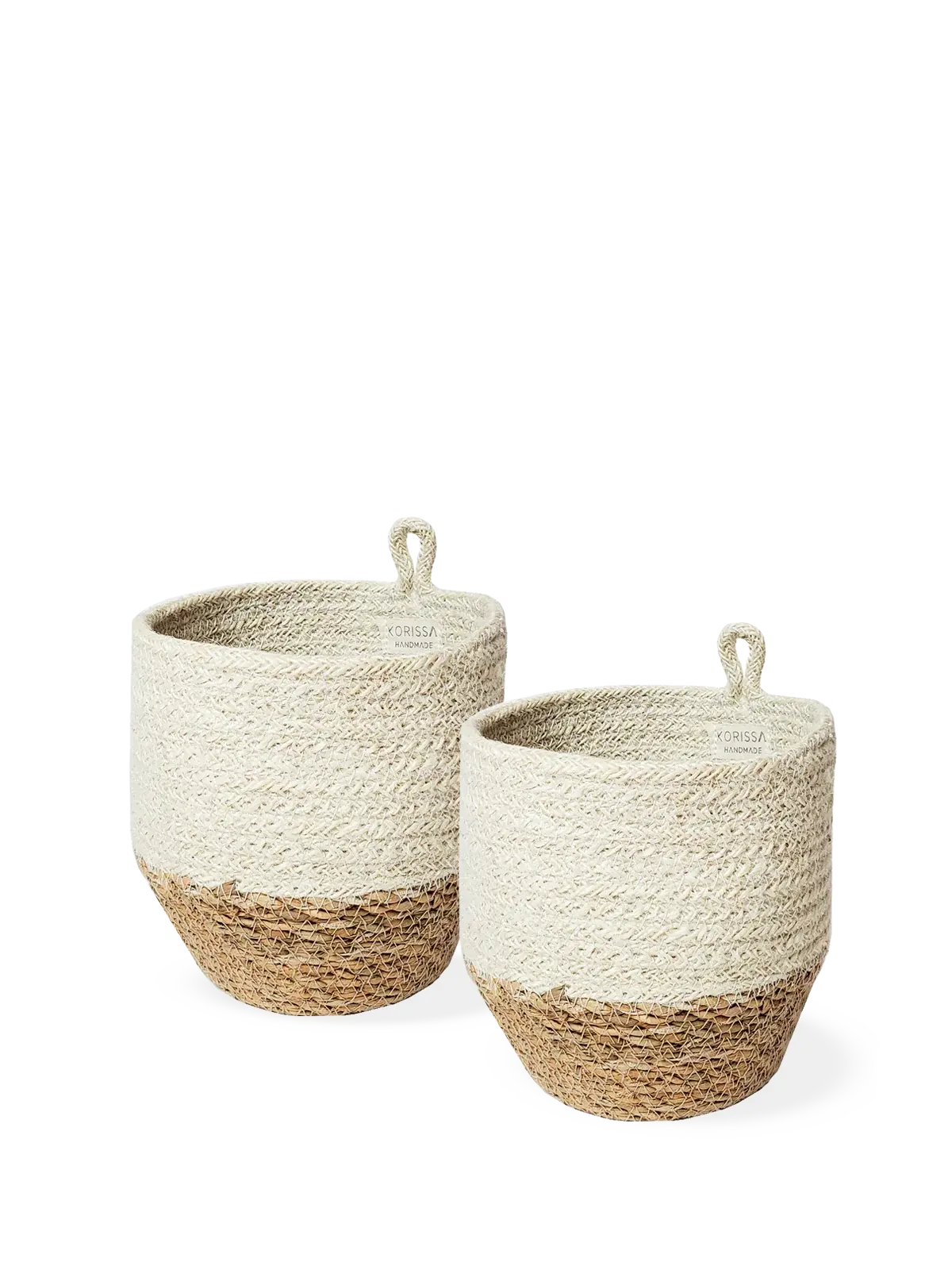 Set of two handmade woven baskets with natural and cream tones, perfect for farmhouse or cottage decor storage.