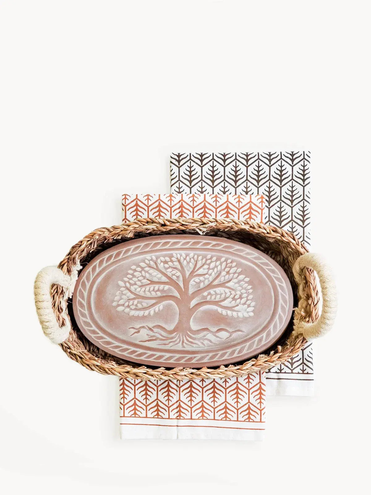 Rattan tray with tree of life ceramic platter and patterned napkins, farmhouse decor
