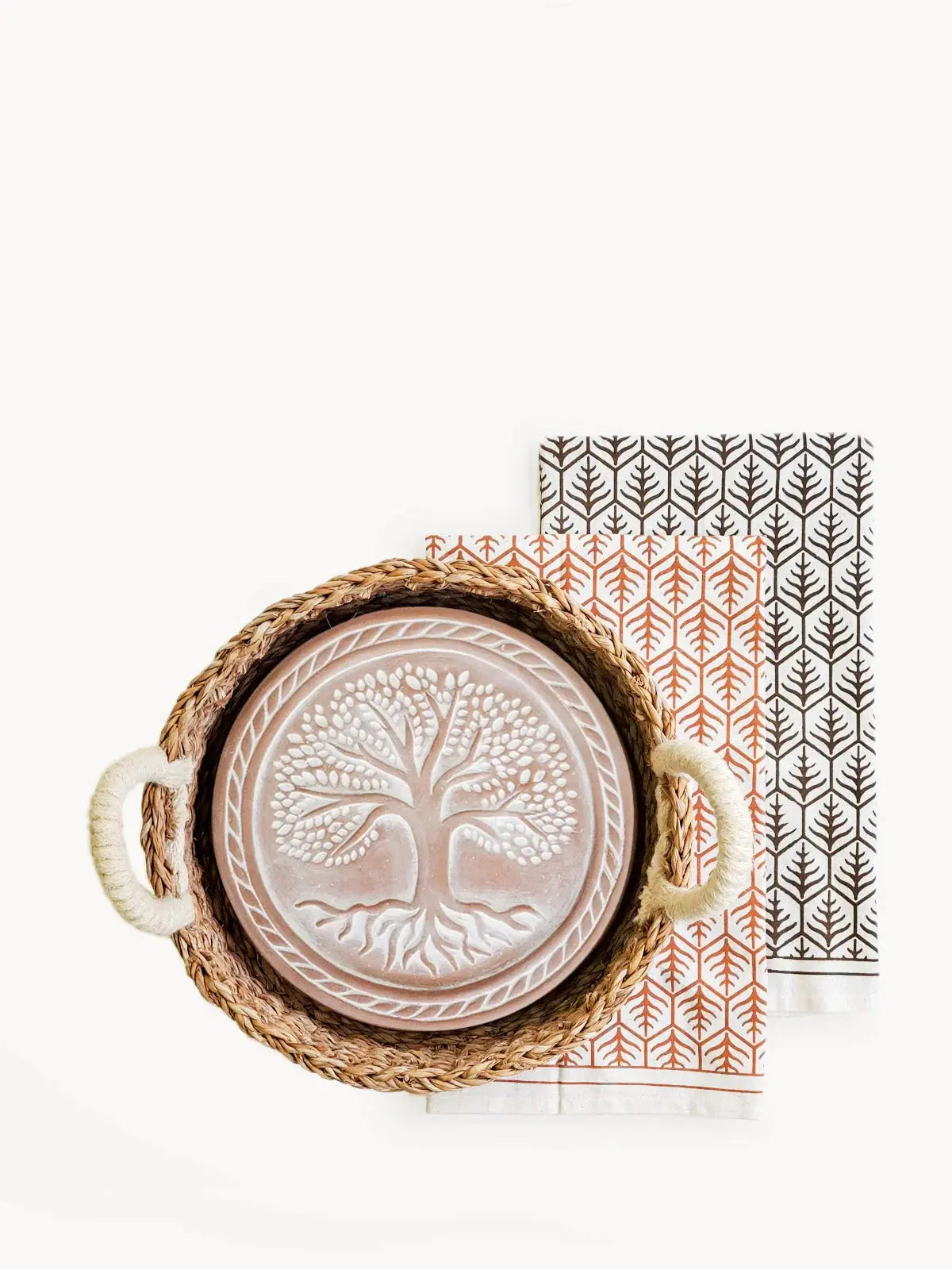 Woven tray with tree of life ceramic plate and patterned napkins, farmhouse decor