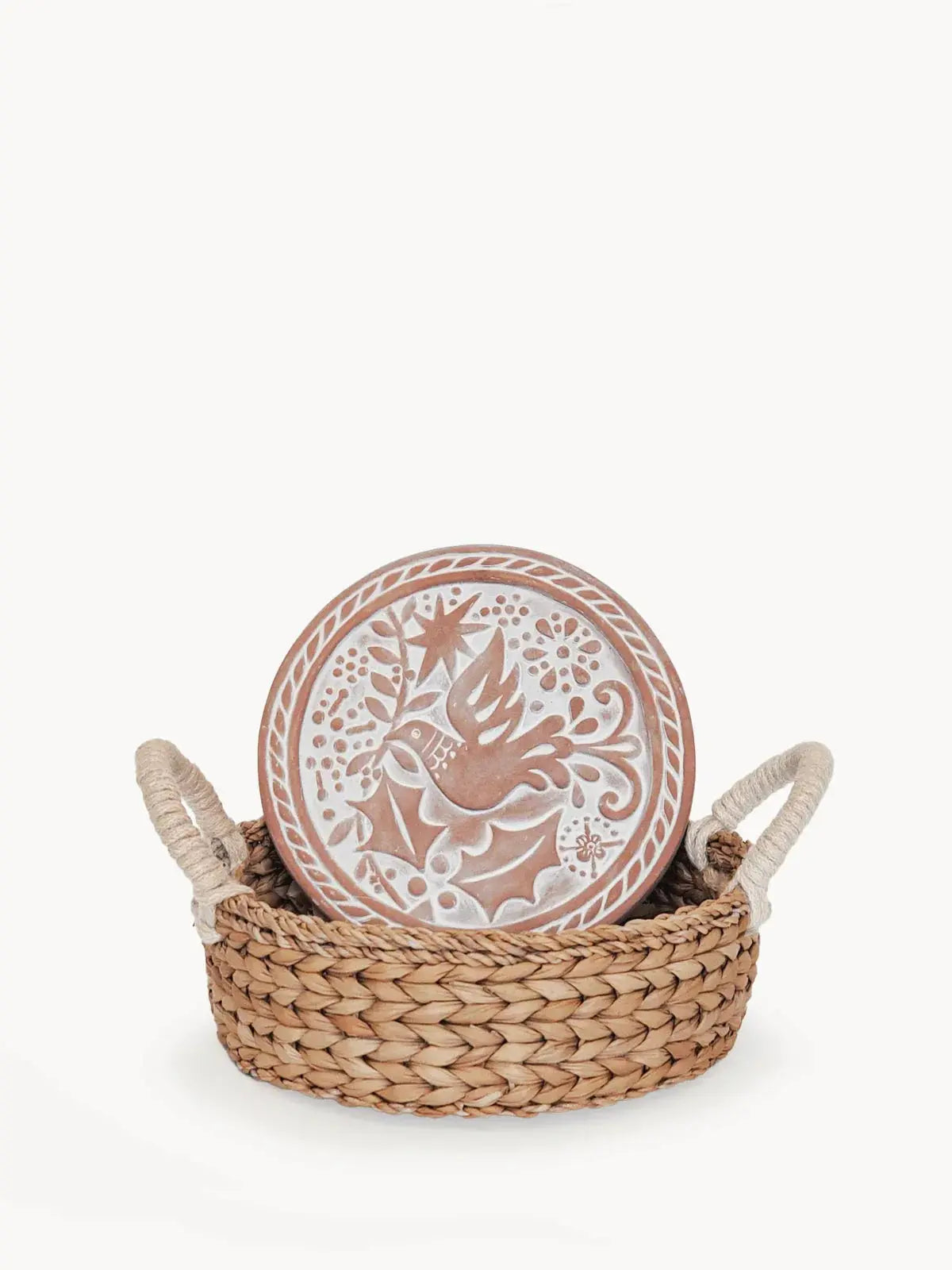Handcrafted ceramic plate with bird and floral design in woven basket, farmhouse decor
