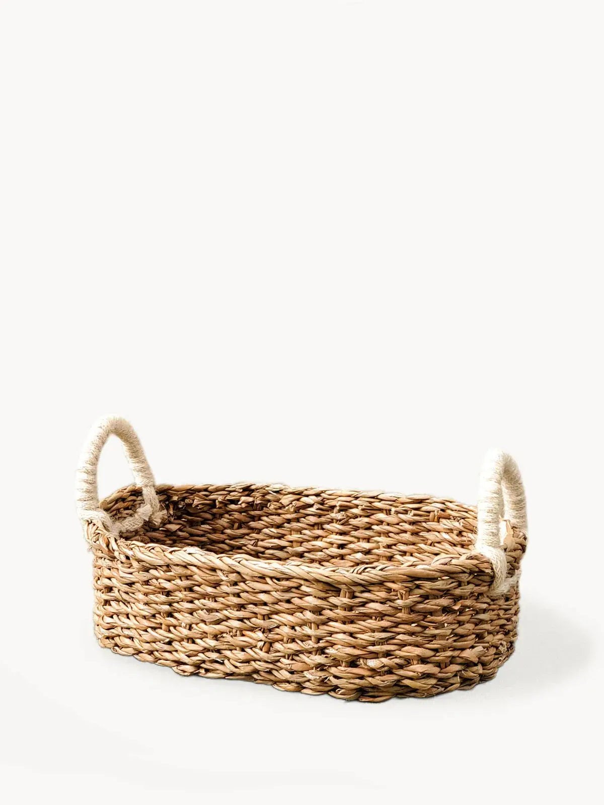 Woven seagrass basket with rope handles for farmhouse or cottage home decor storage
