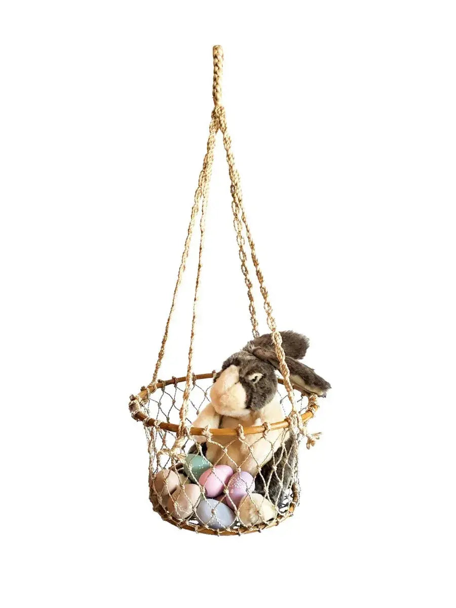 Hanging rope basket with plush bunny and pastel Easter eggs, cozy farmhouse decor