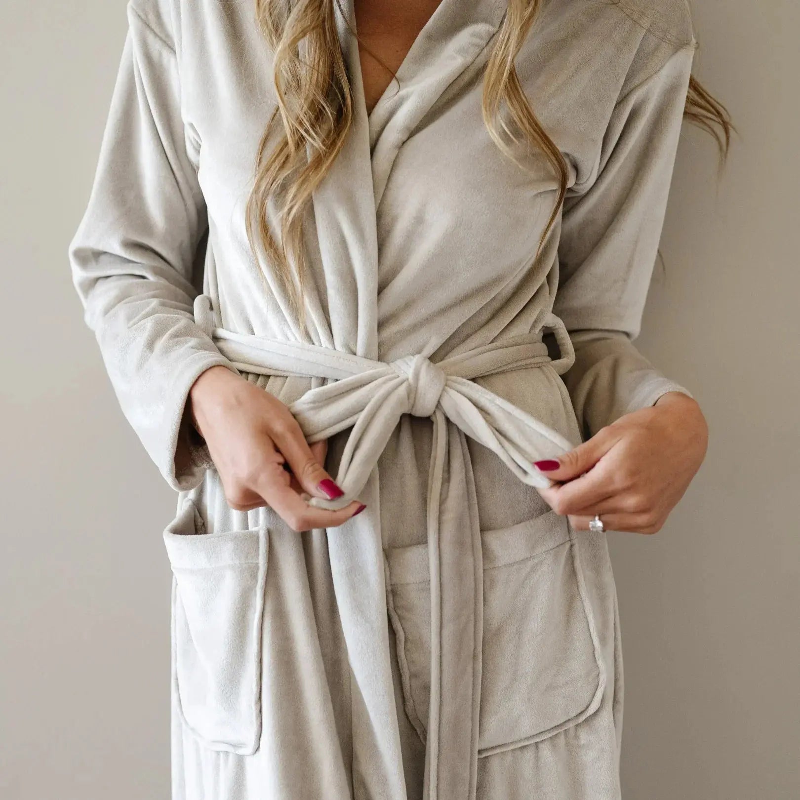 Cozy beige plush robe with tie belt and pockets, perfect for farmhouse bath essentials and relaxing home decor.