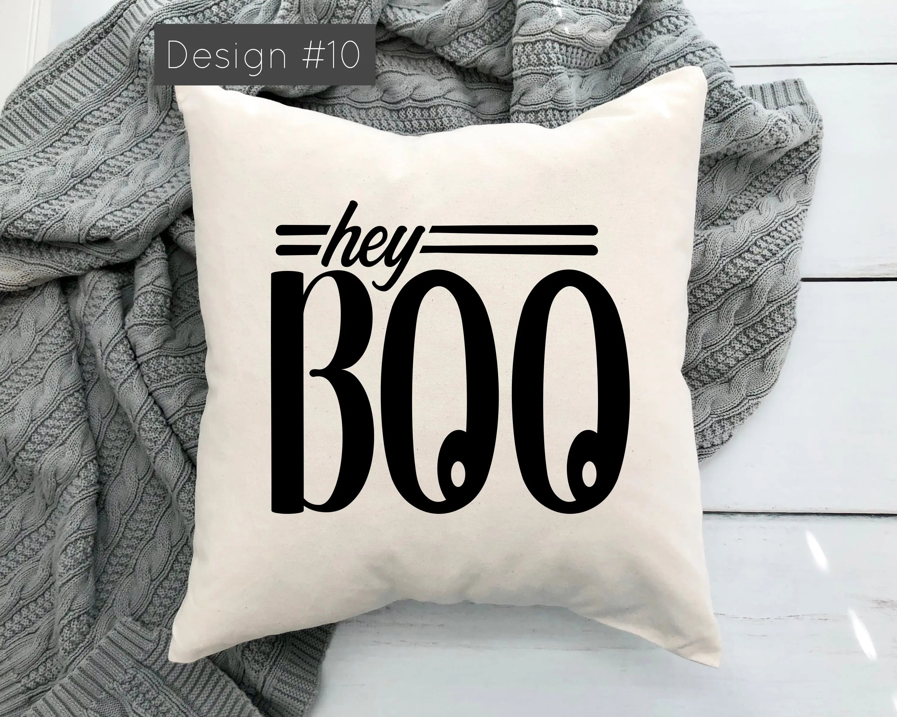 Pillow with 'hey BOO' text on a white background