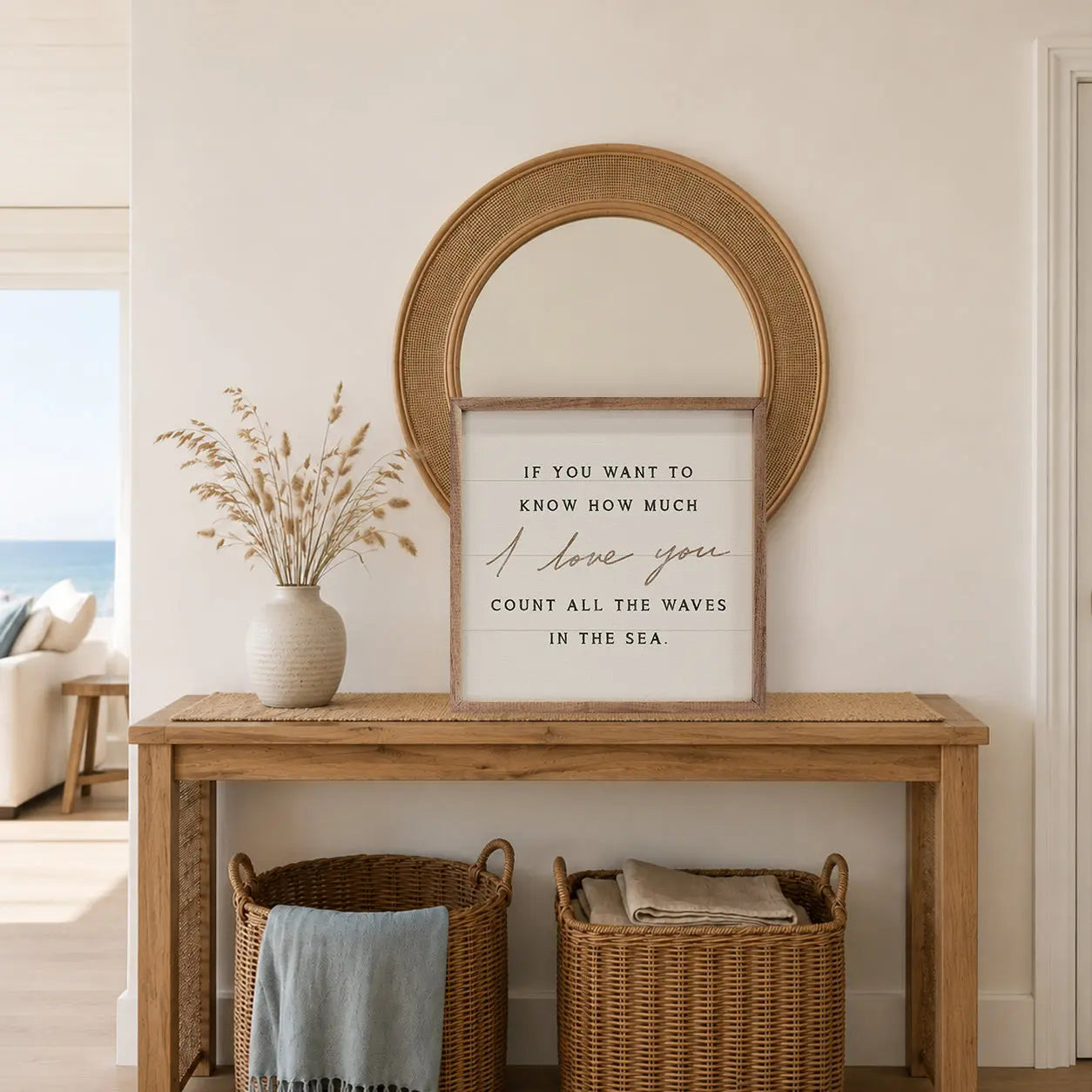 Nautical-themed room with wooden console table, round mirror, and motivational quote sign.