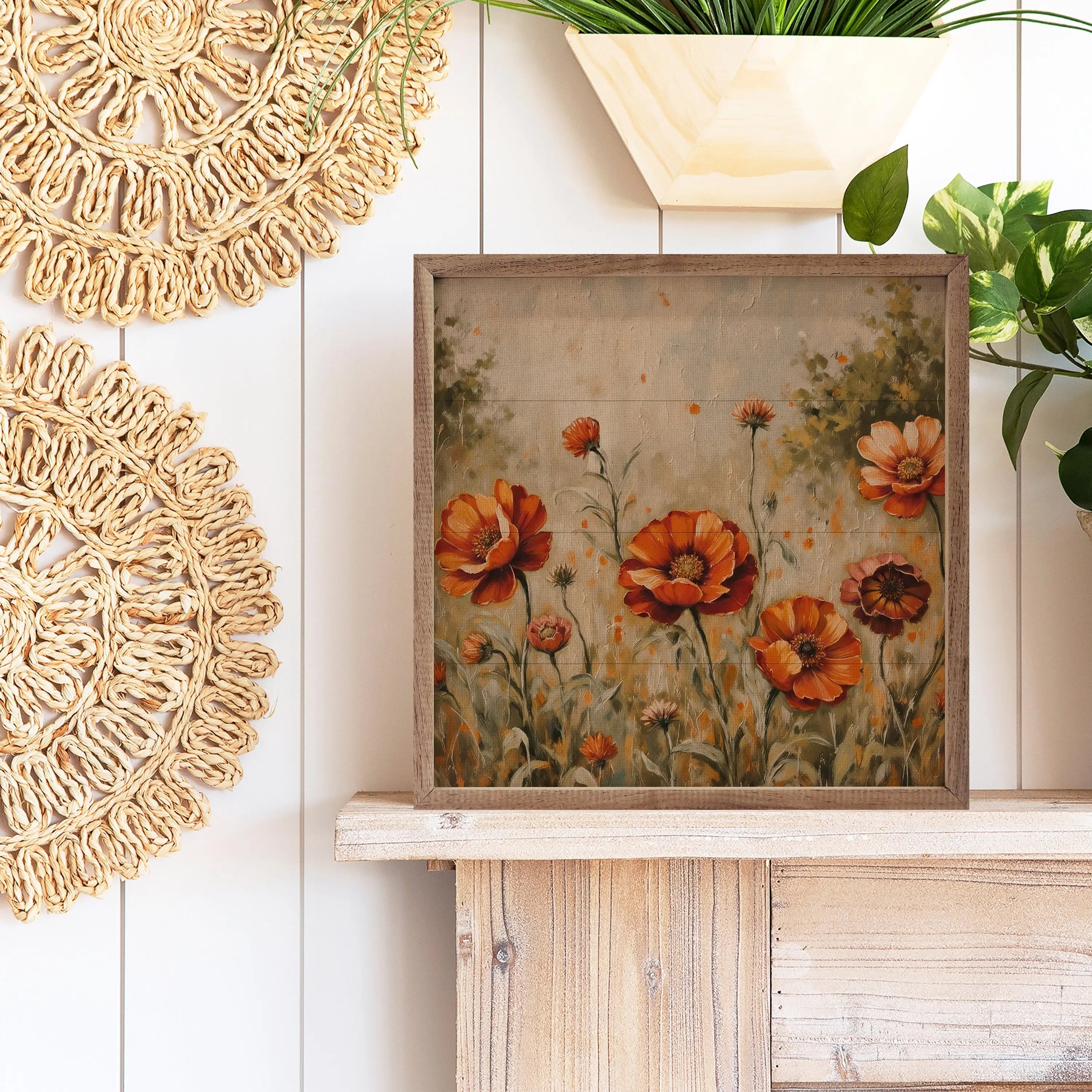 Decorative wall art with floral design on a wooden shelf, surrounded by plants and decorative items.