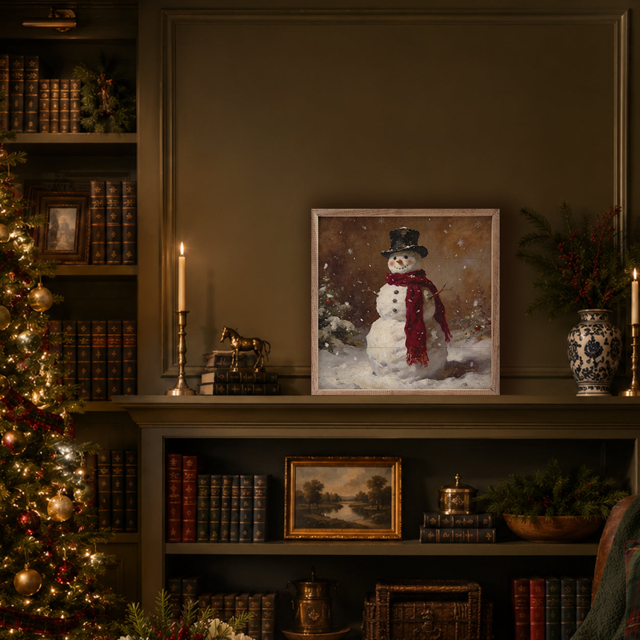 Framed picture of a snowman on a shelf with a decorated Christmas tree and books in the background.