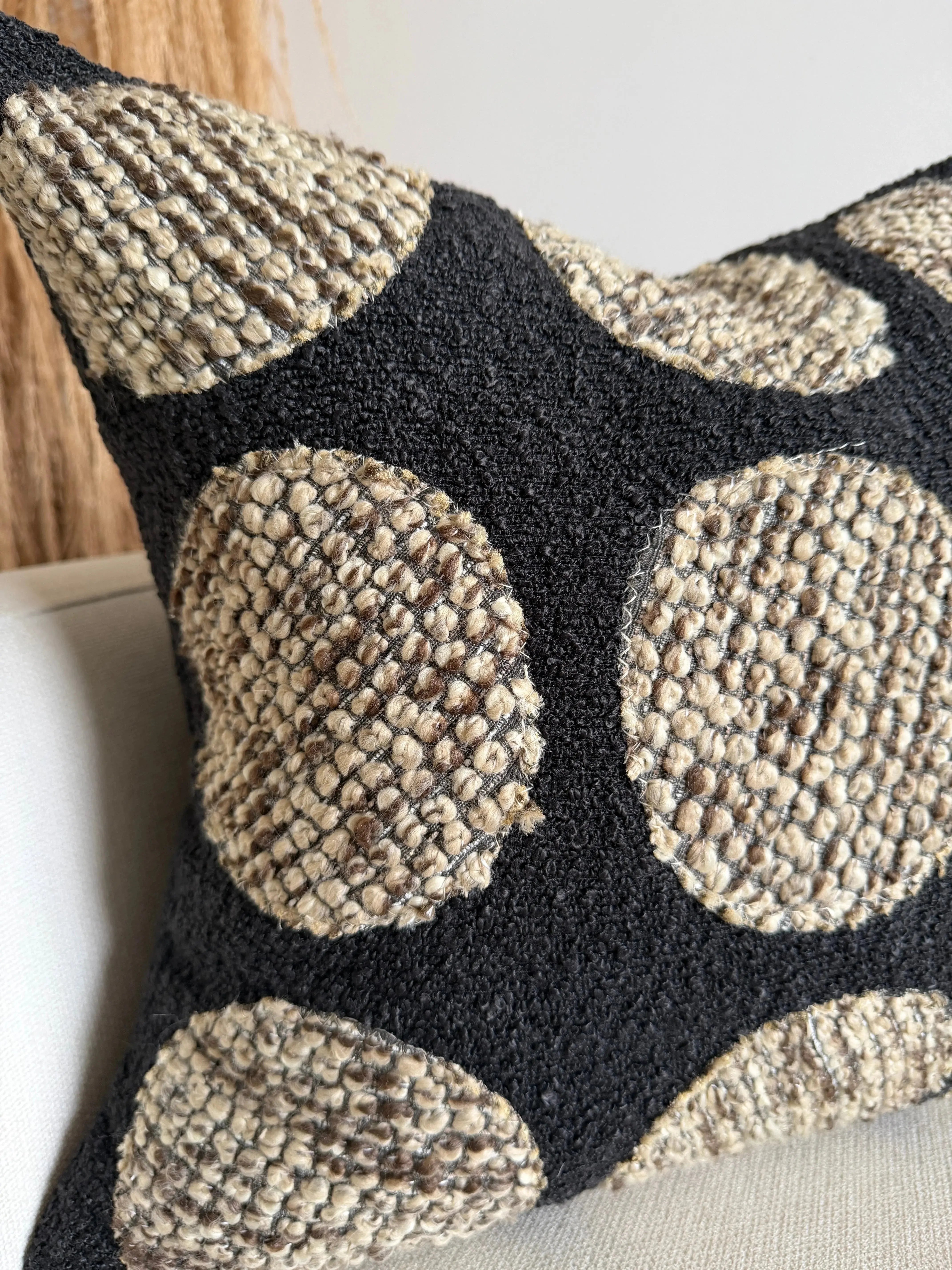 Cozy farmhouse throw pillow with black and beige geometric pattern, textured woven design for living room decor