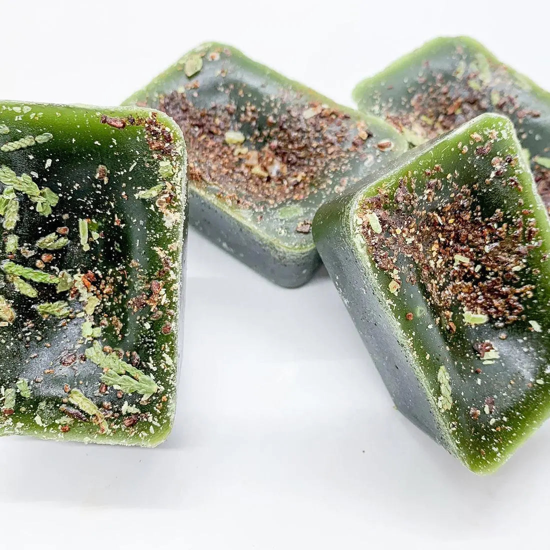 Green square blocks with a textured surface on a white background