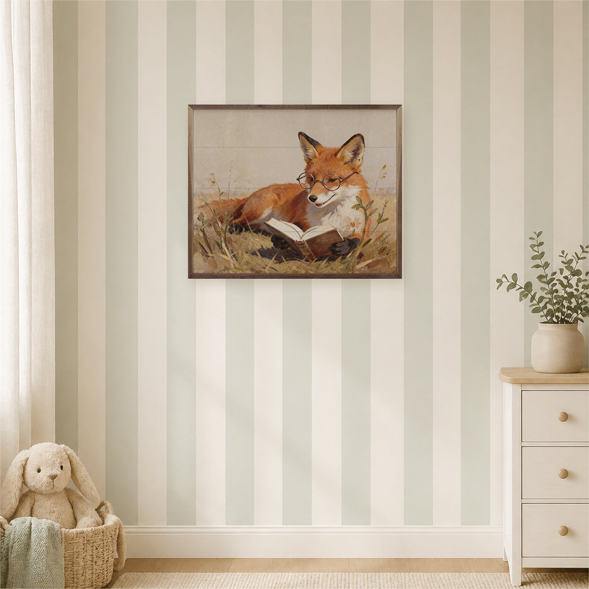 A framed art print of a fox reading a book, displayed on a wall with vertical stripes in a styled nursery or children's room setting.