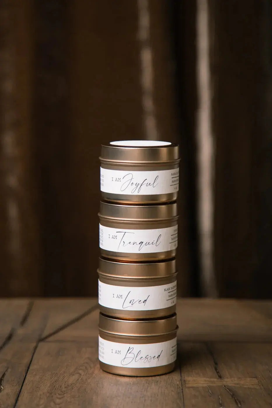 Stacked gold tins with affirmations like 'I Am Joyful' for cozy farmhouse home decor and thoughtful gifts