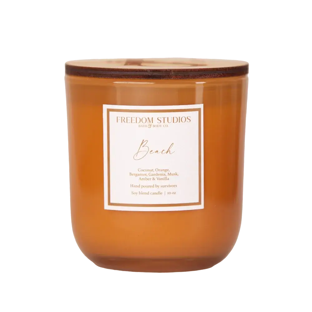 Beach scented soy candle in amber glass jar with wooden lid, cozy home decor