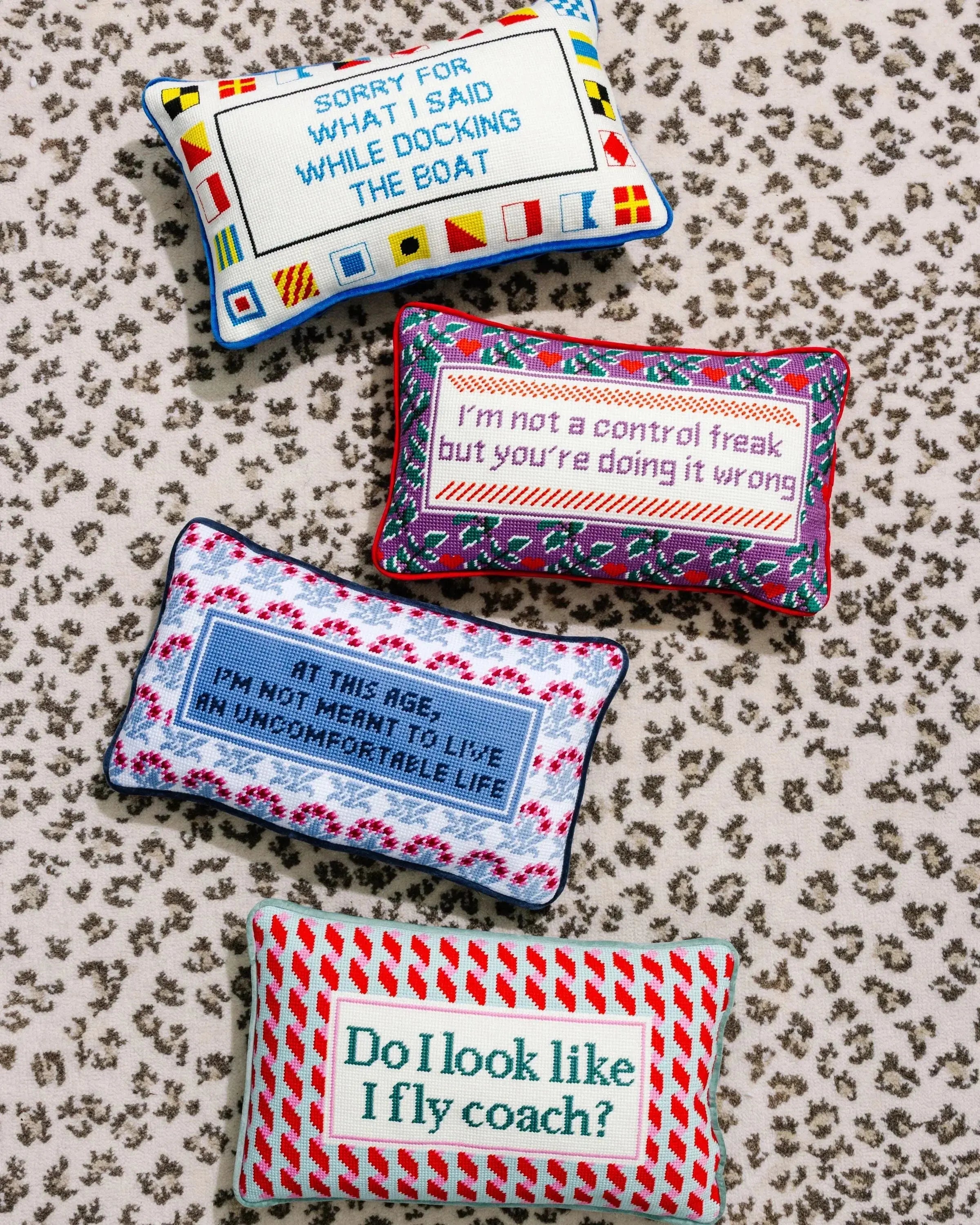 Four funny embroidered accent pillows with witty quotes, perfect for cozy farmhouse or cottage style home decor.