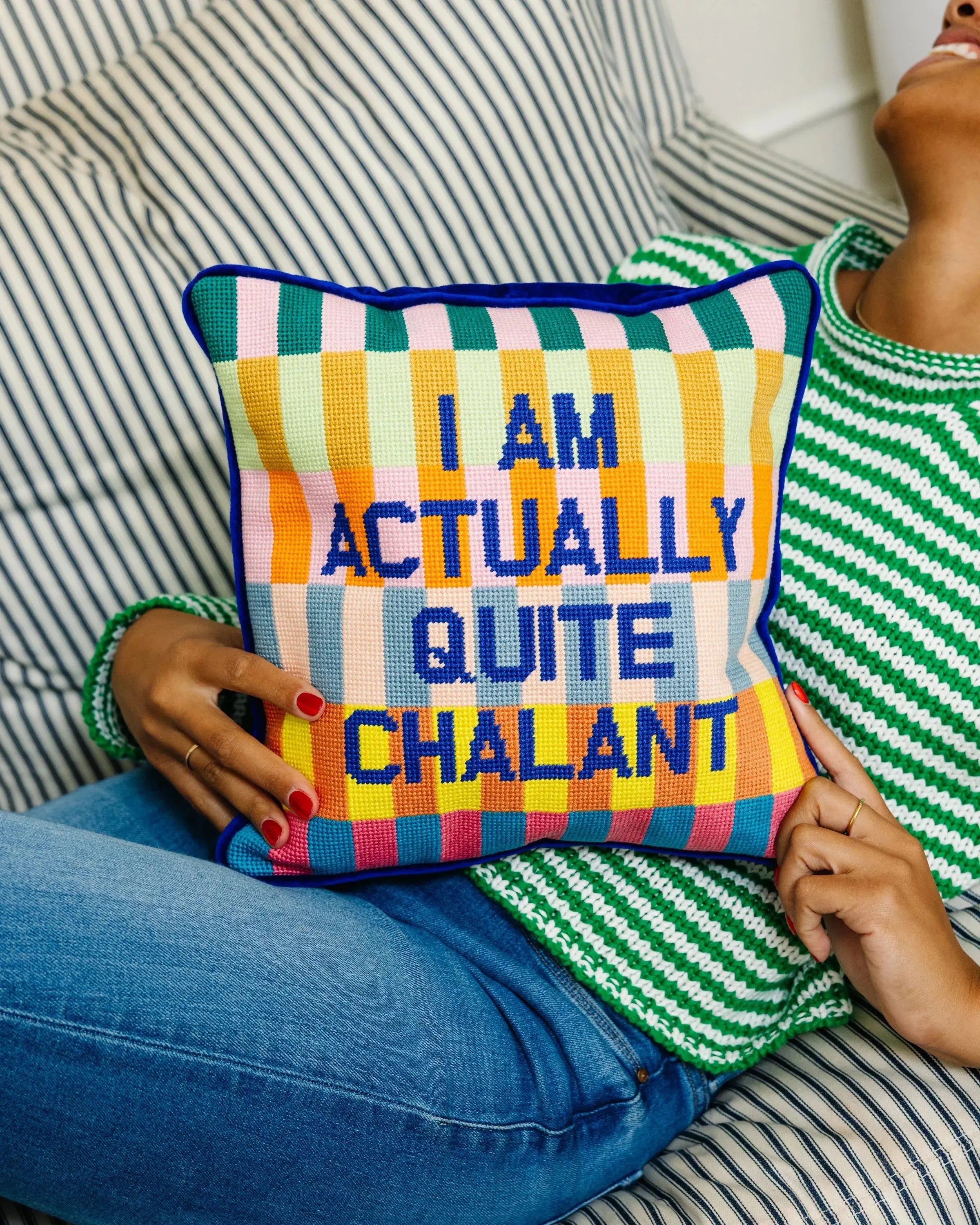 Colorful cross-stitch pillow with 'I AM ACTUALLY QUITE CHALANT' text, cozy farmhouse decor accent