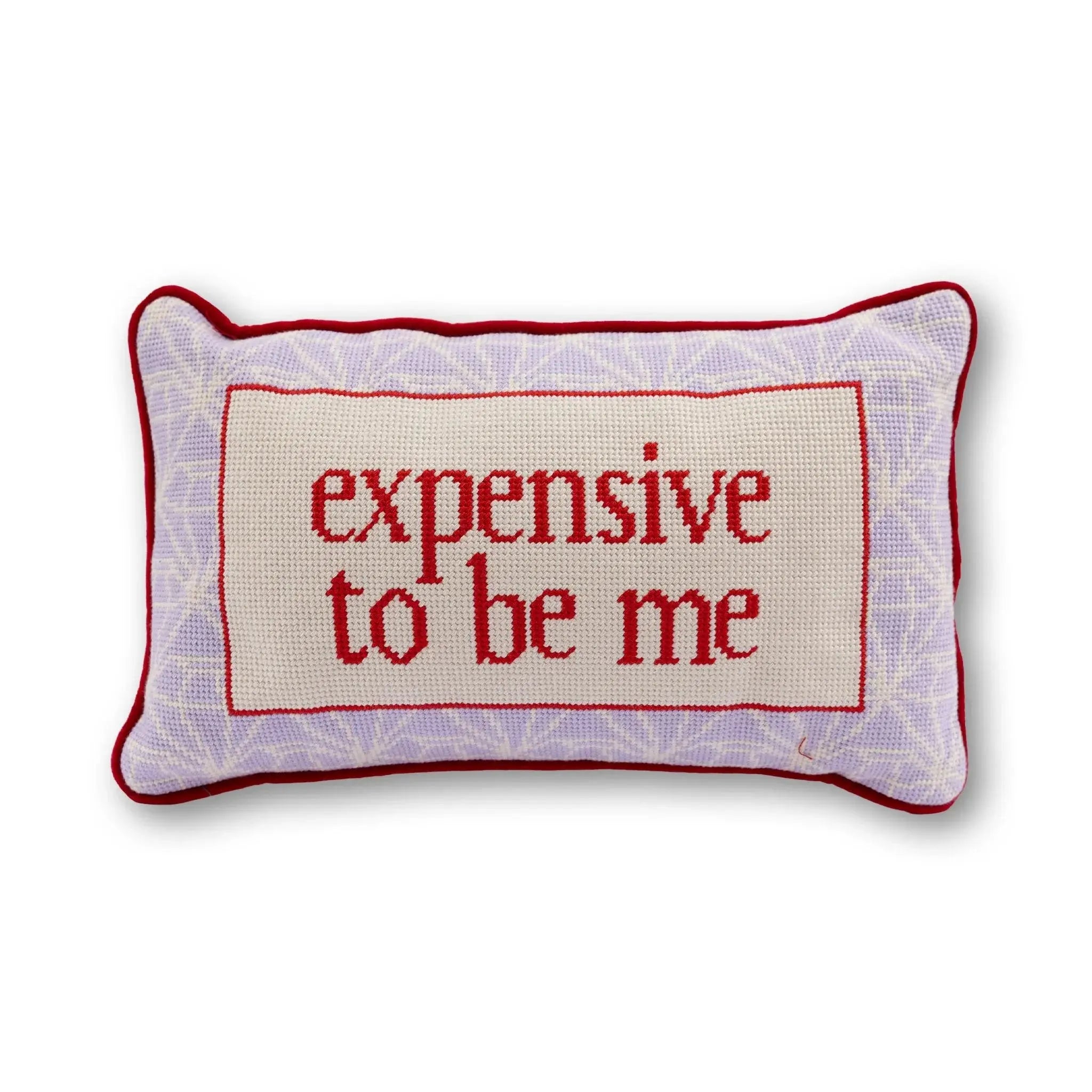 Decorative pillow with 'expensive to be me' text on a white background