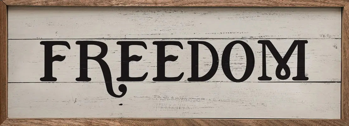 Wooden sign with 'FREEDOM' text in a rustic frame