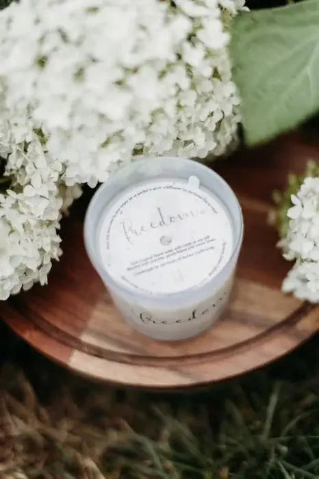 Freedom soy candle in rustic wood tray with white hydrangeas, cozy farmhouse home decor