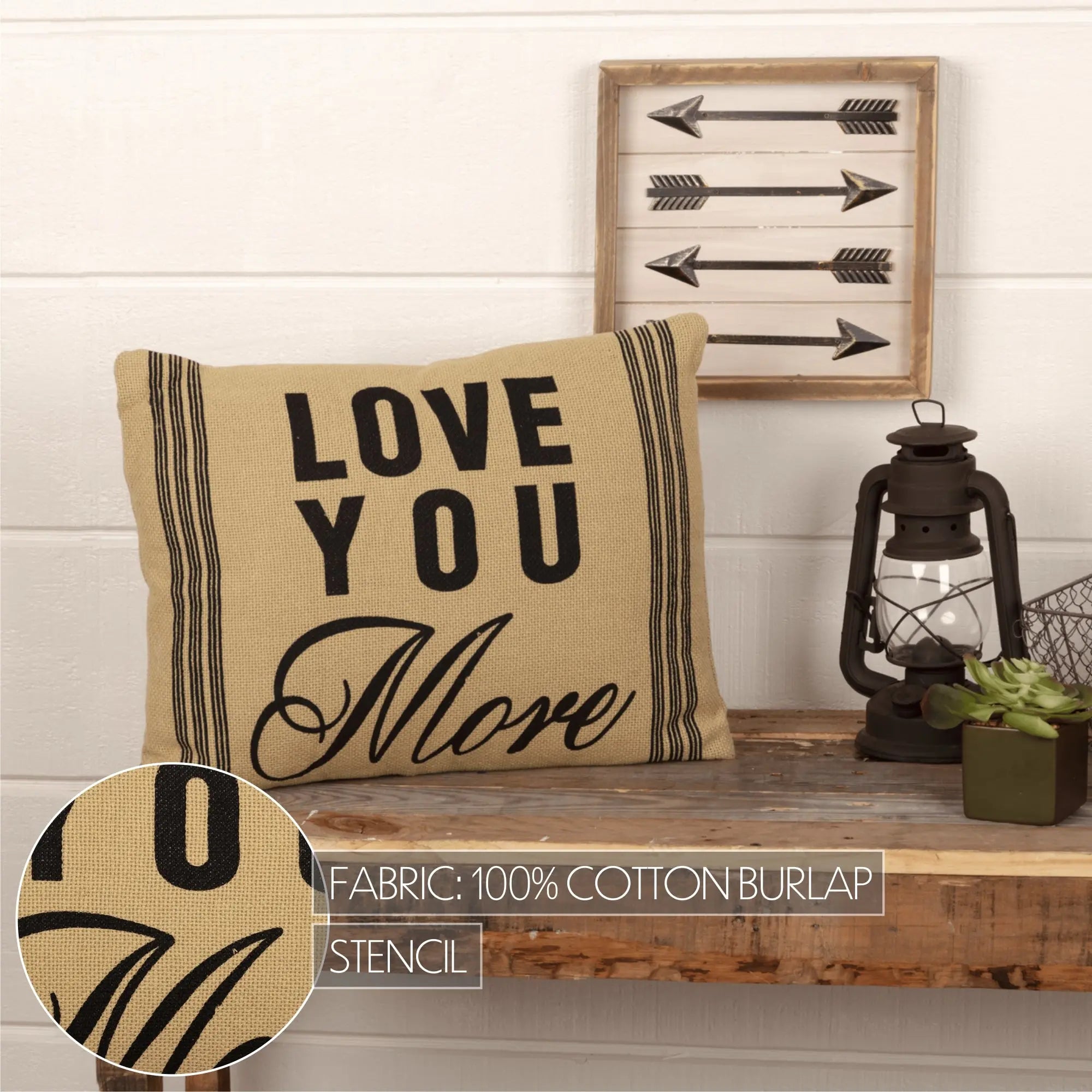 Love You More burlap pillow with black stencil text, farmhouse decor on wooden shelf with lantern and arrows