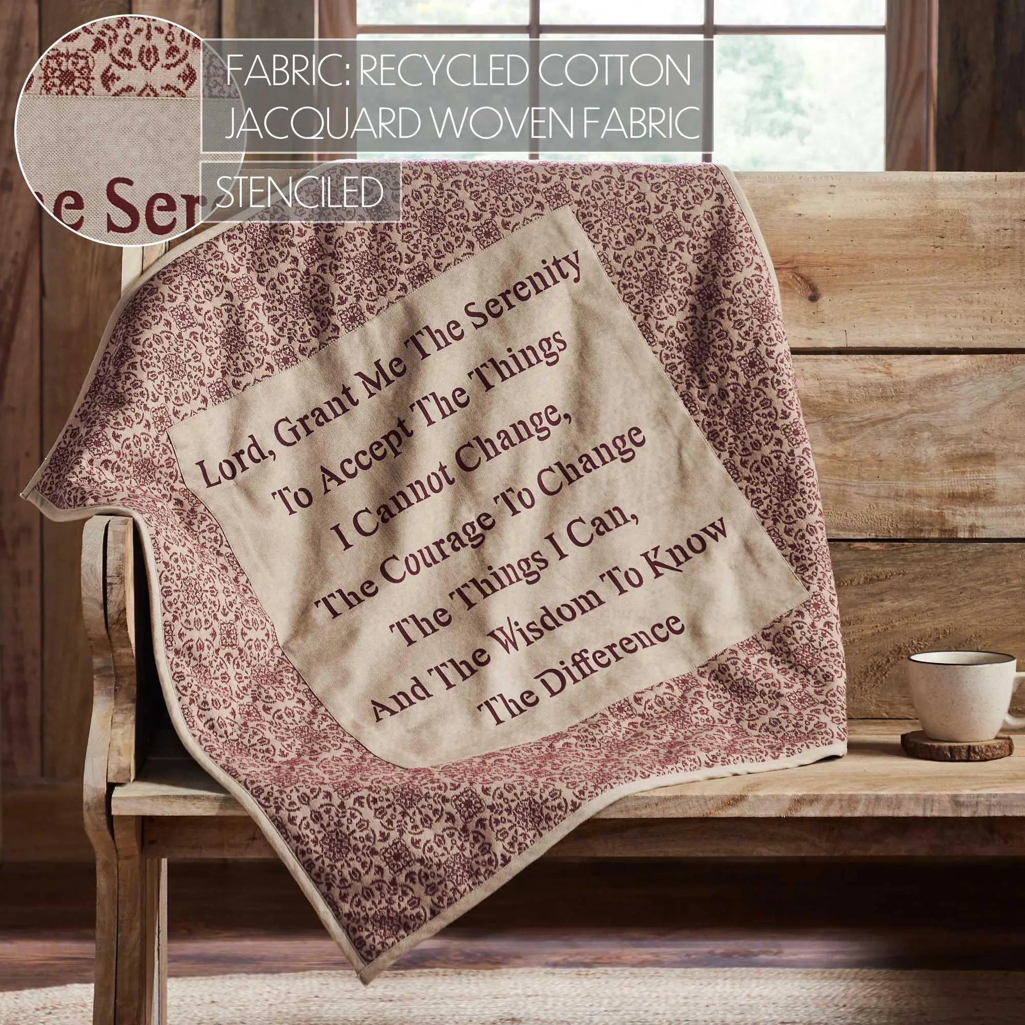 Textile with 'Serenity Prayer' on a wooden bench with a cup and coaster.