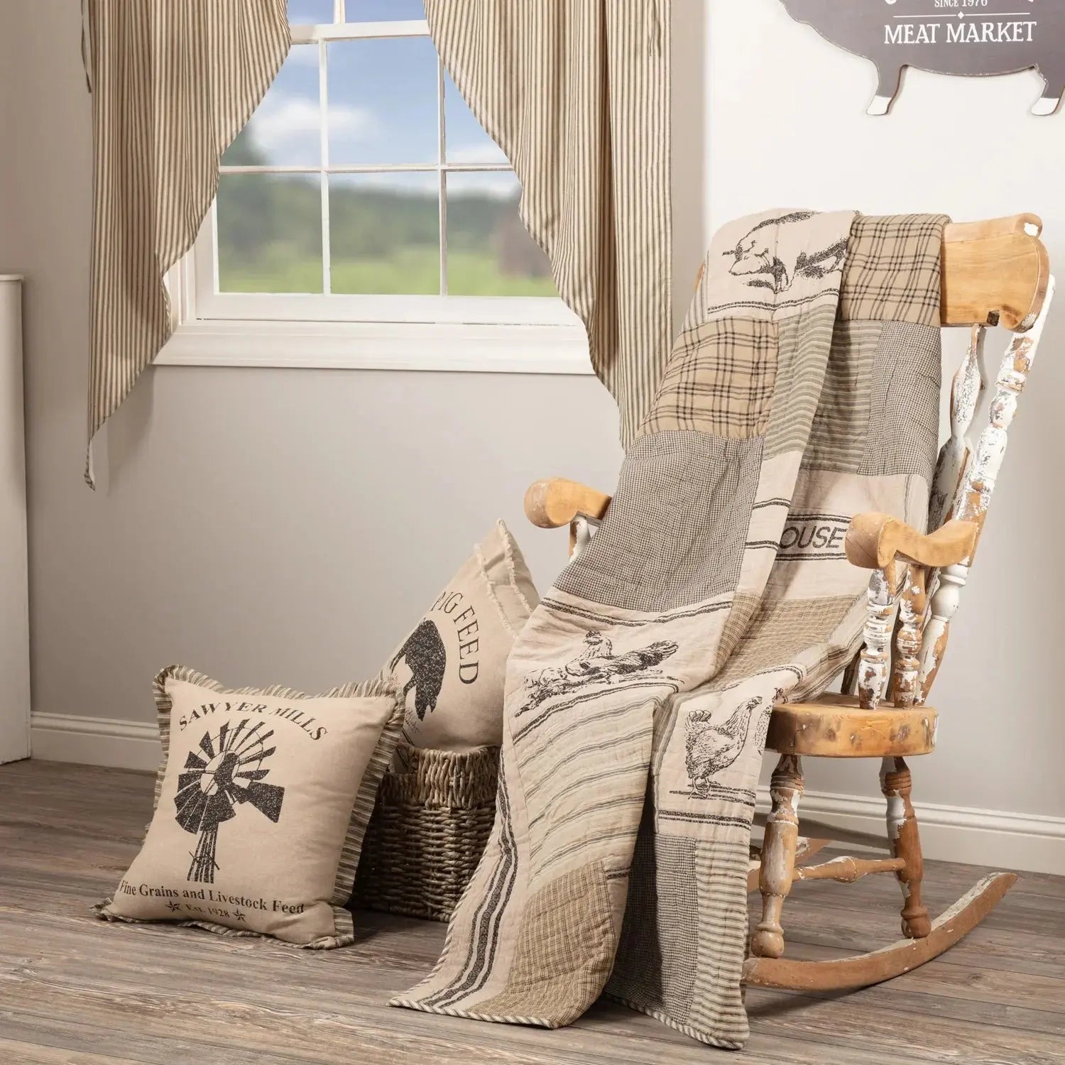 Farmhouse rocking chair with patchwork quilt, rustic pillows, and striped curtains in cozy cottage decor