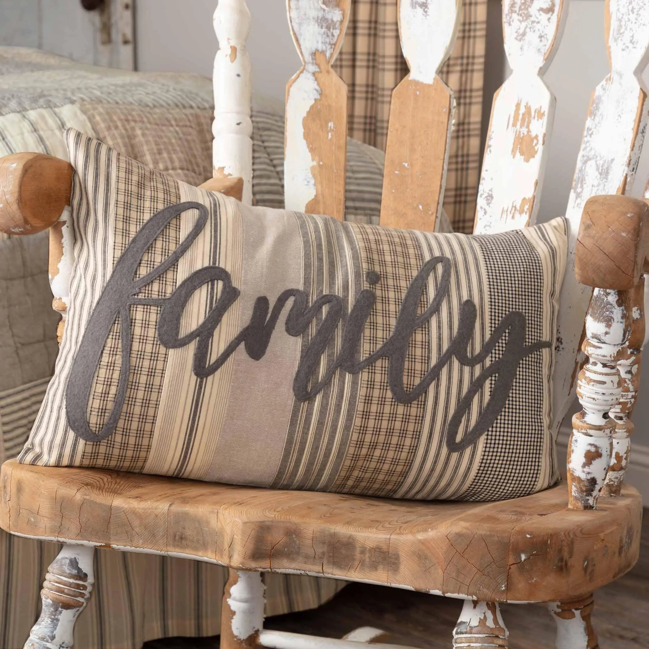 Farmhouse 'Family' pillow on distressed rocking chair, cozy cottage decor with plaid and stripes