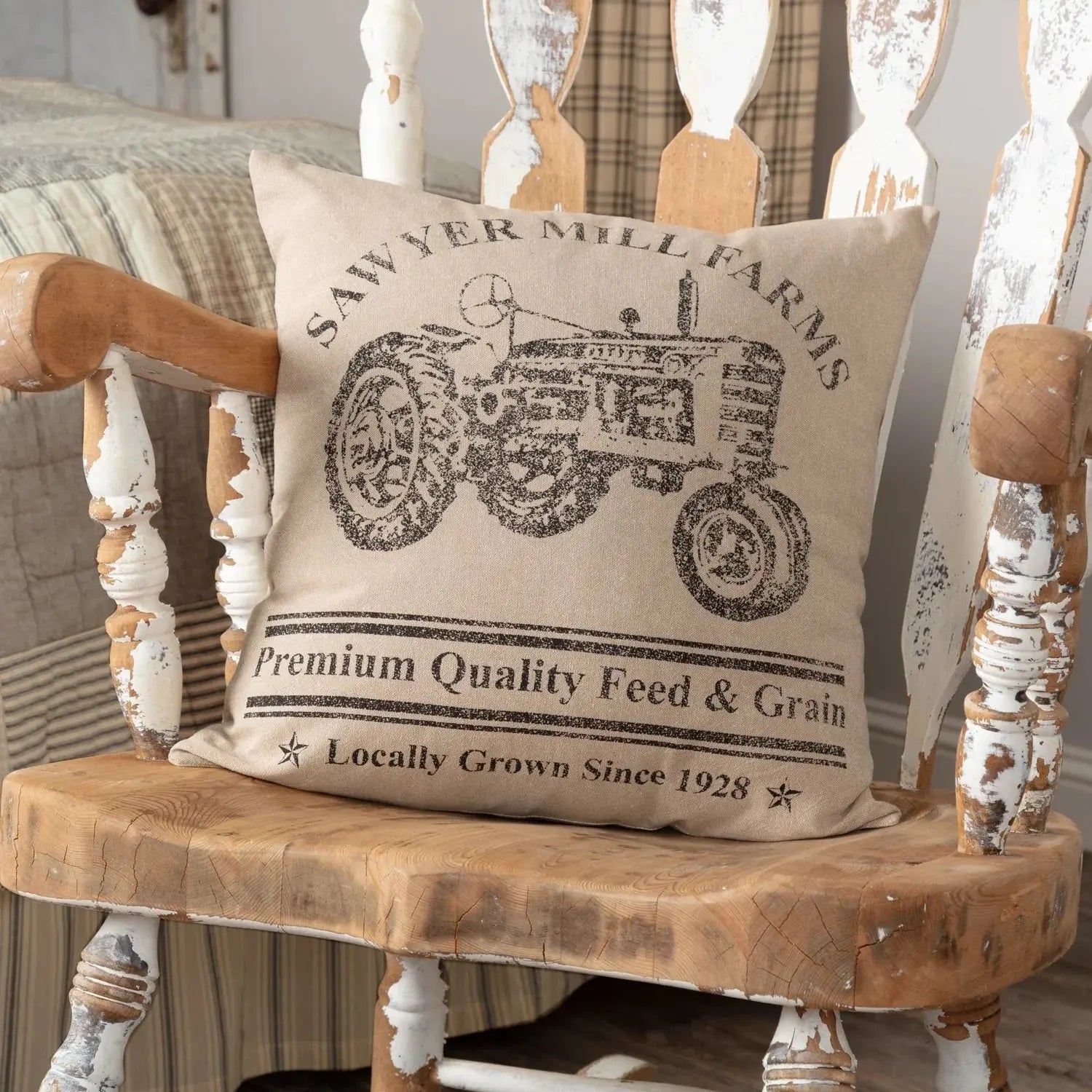 Decorative pillow with tractor design on a wooden bench
