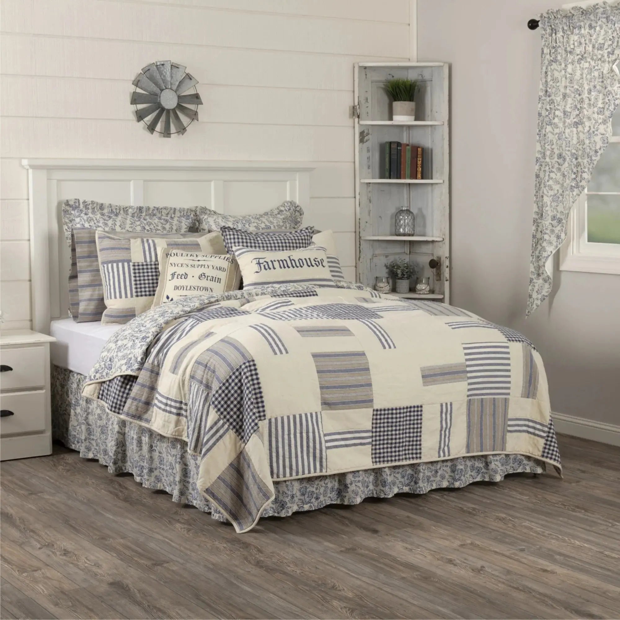 Cozy farmhouse bedroom with patchwork quilt, floral bedding, and rustic decor