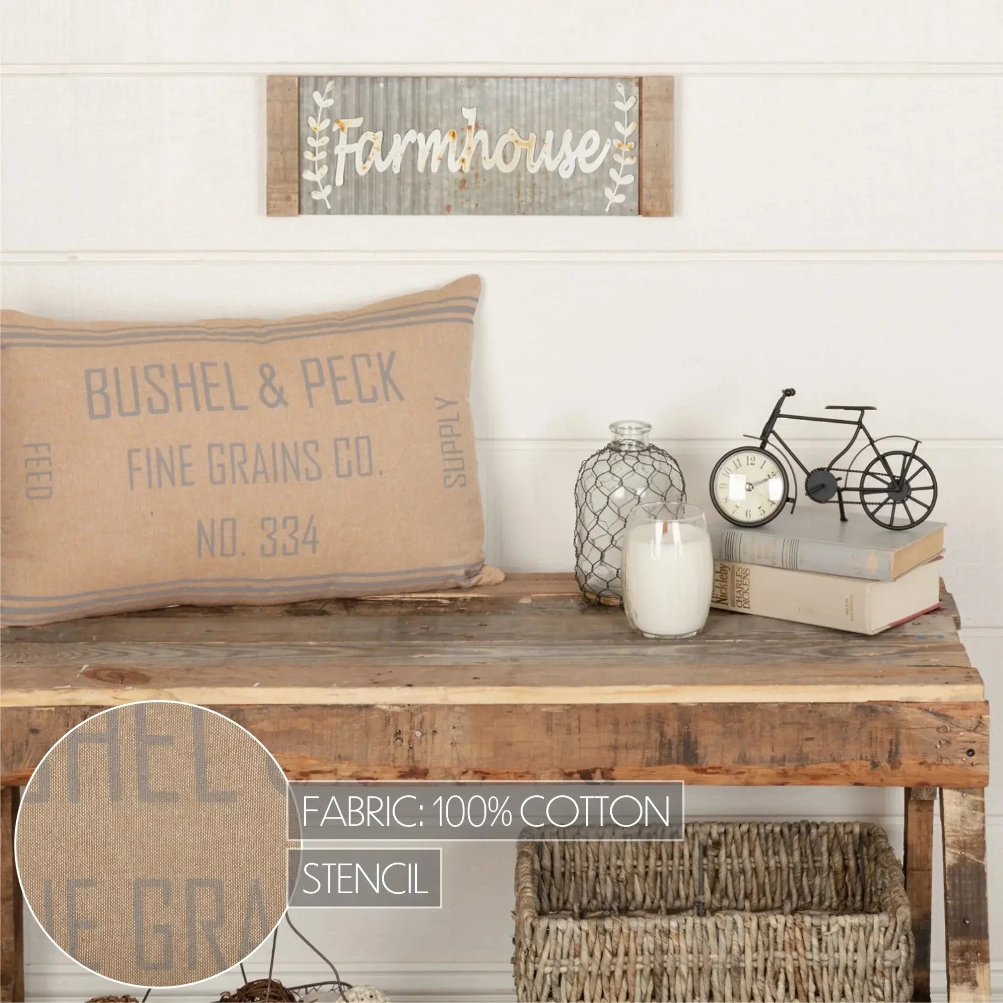 Farmhouse decor with rustic wood sign, grain sack pillow, candle, and vintage books on console table