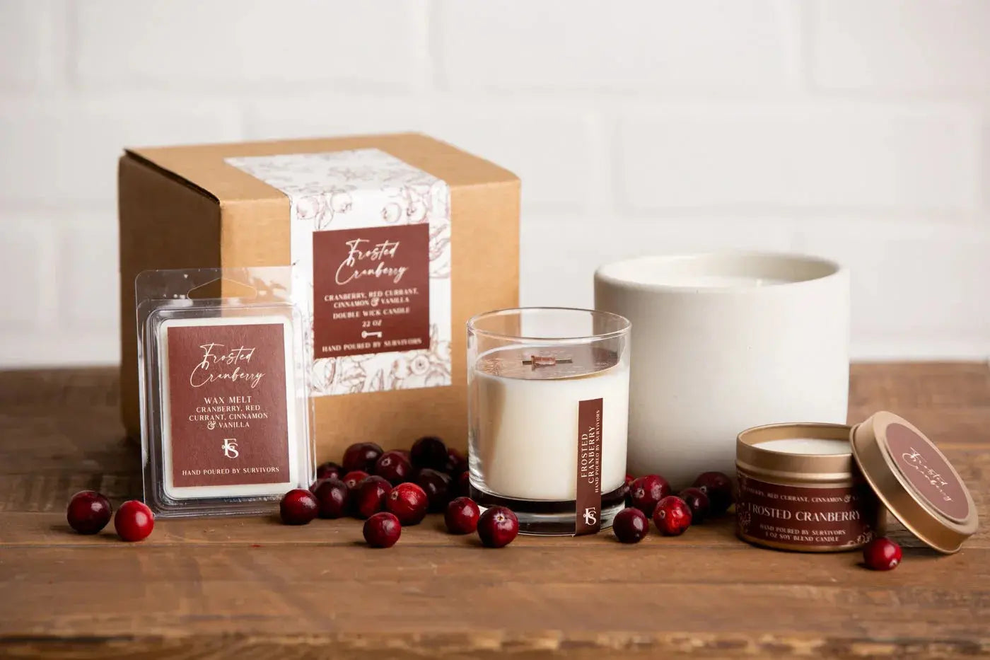 Frosted Cranberry scented candles and wax melts with fresh cranberries on rustic wood, cozy farmhouse decor