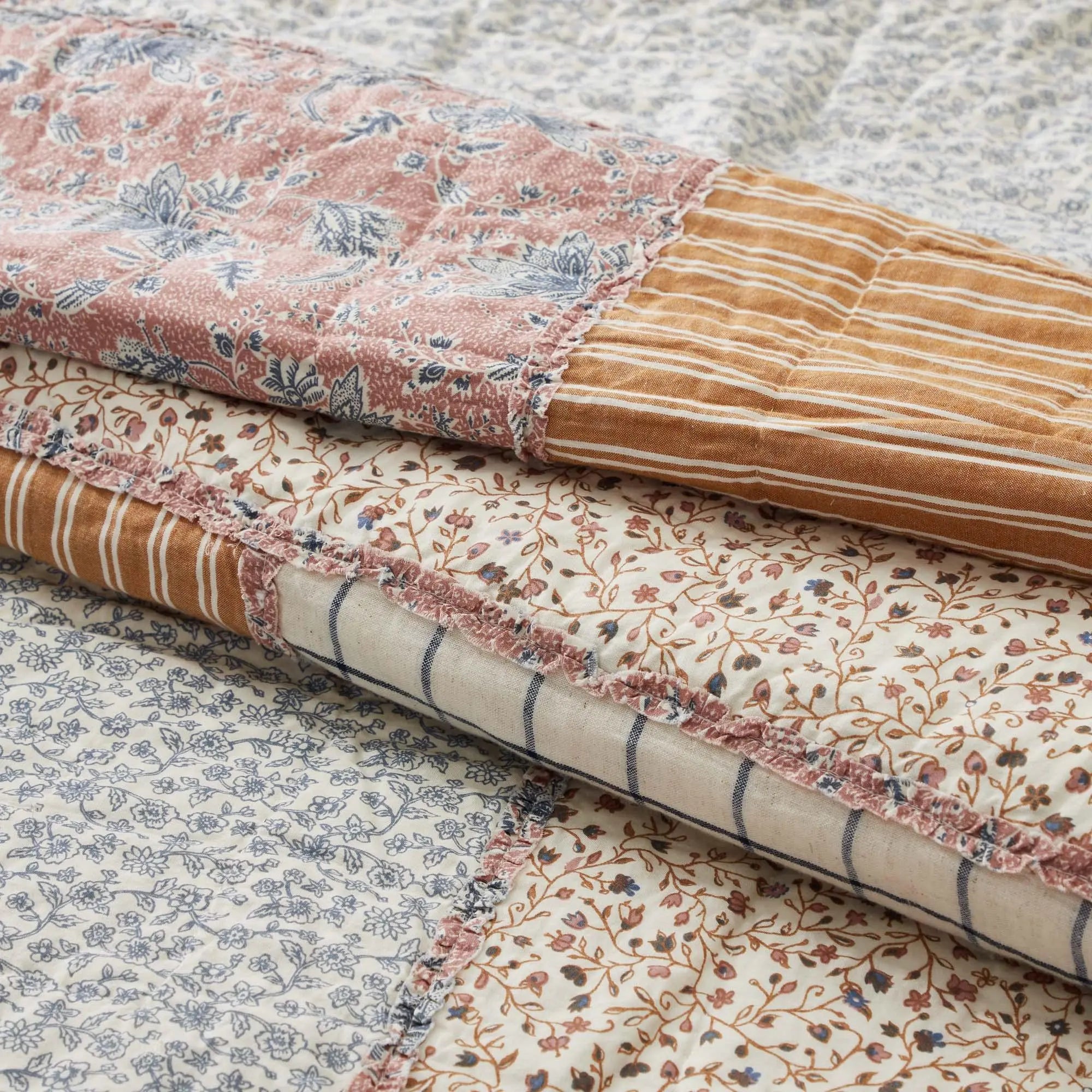 Cozy farmhouse quilt set with floral and stripe patterns, soft cotton bedding for cottage style decor