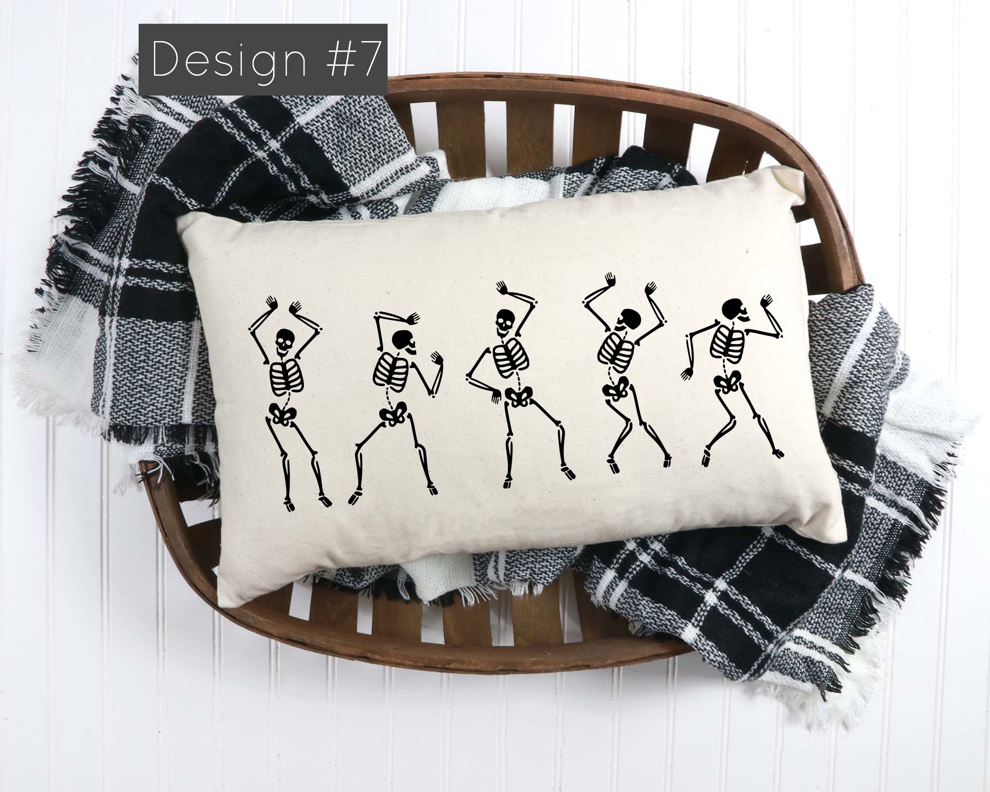 Decorative pillow with skeleton design on a wooden chair with plaid blanket
