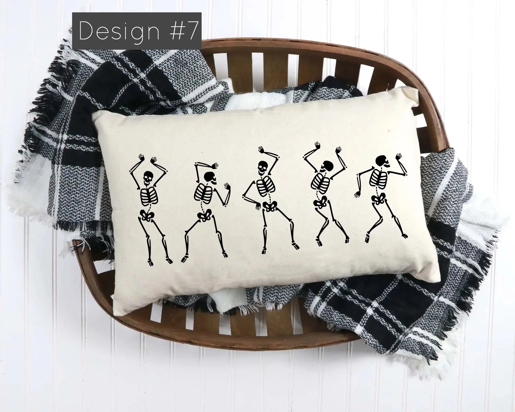 Decorative pillow with skeleton design on a wooden chair with plaid blanket