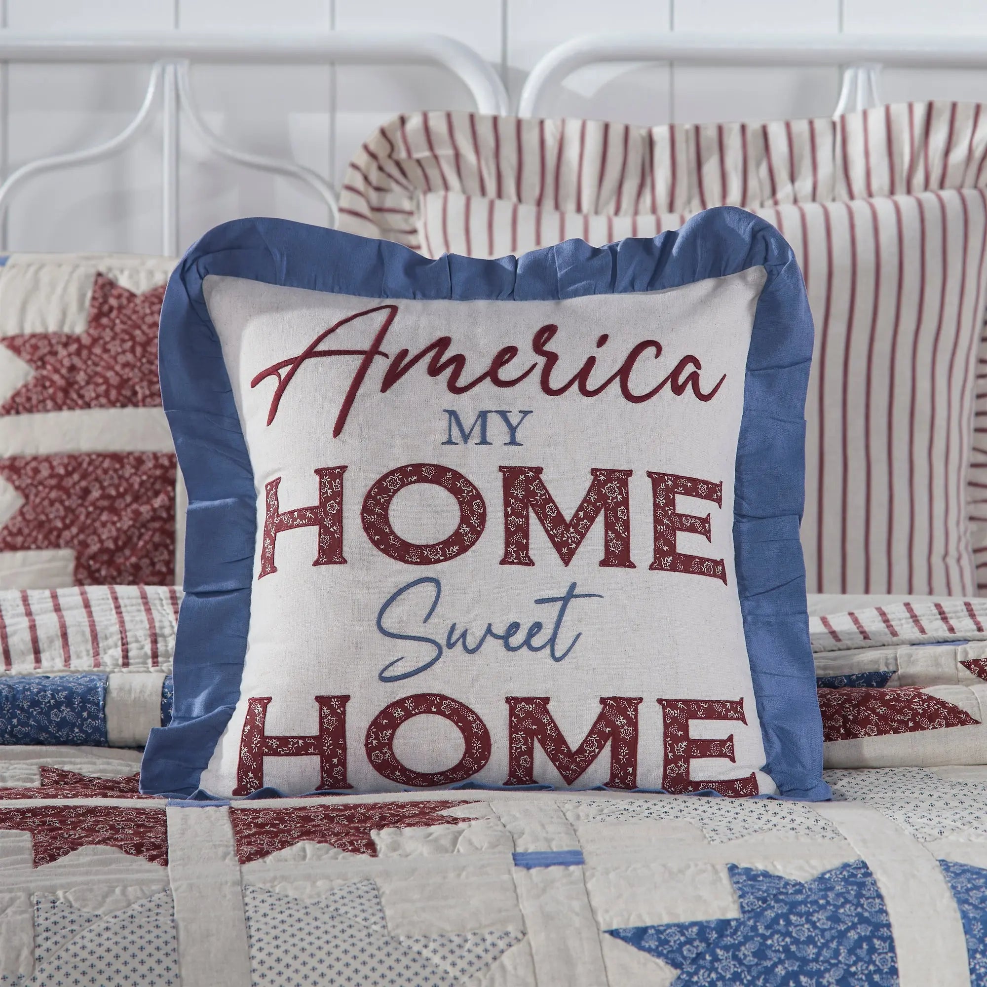 Decorative pillow with 'America My Home Sweet Home' text on a quilted background