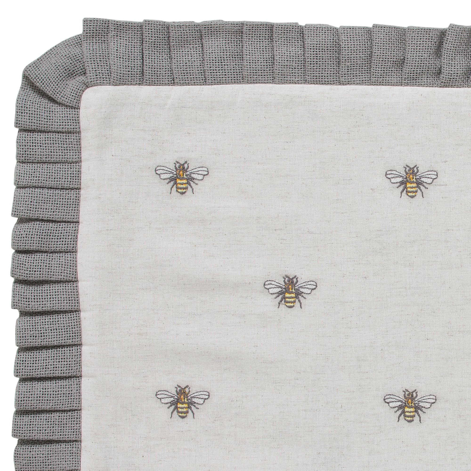 Gray ruffled throw blanket with embroidered bees, cozy farmhouse decor