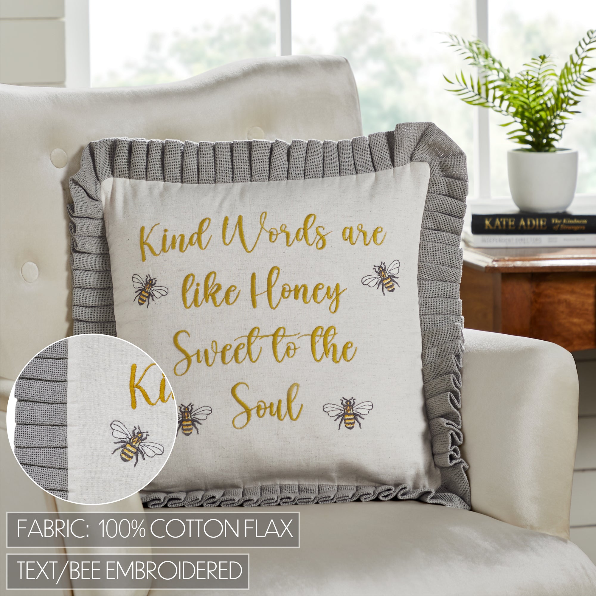 Decorative pillow with inspirational quote and bee design on a couch