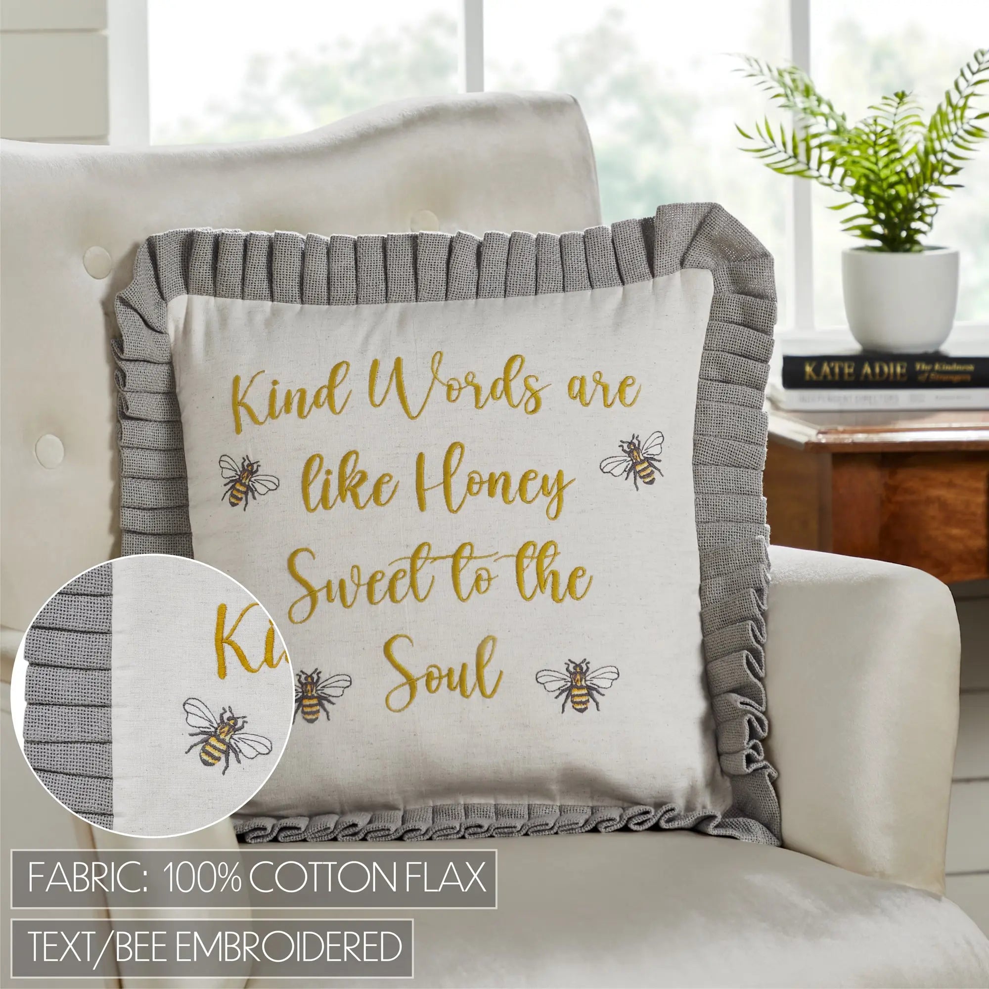 Decorative pillow with inspirational quote and bee design on a couch
