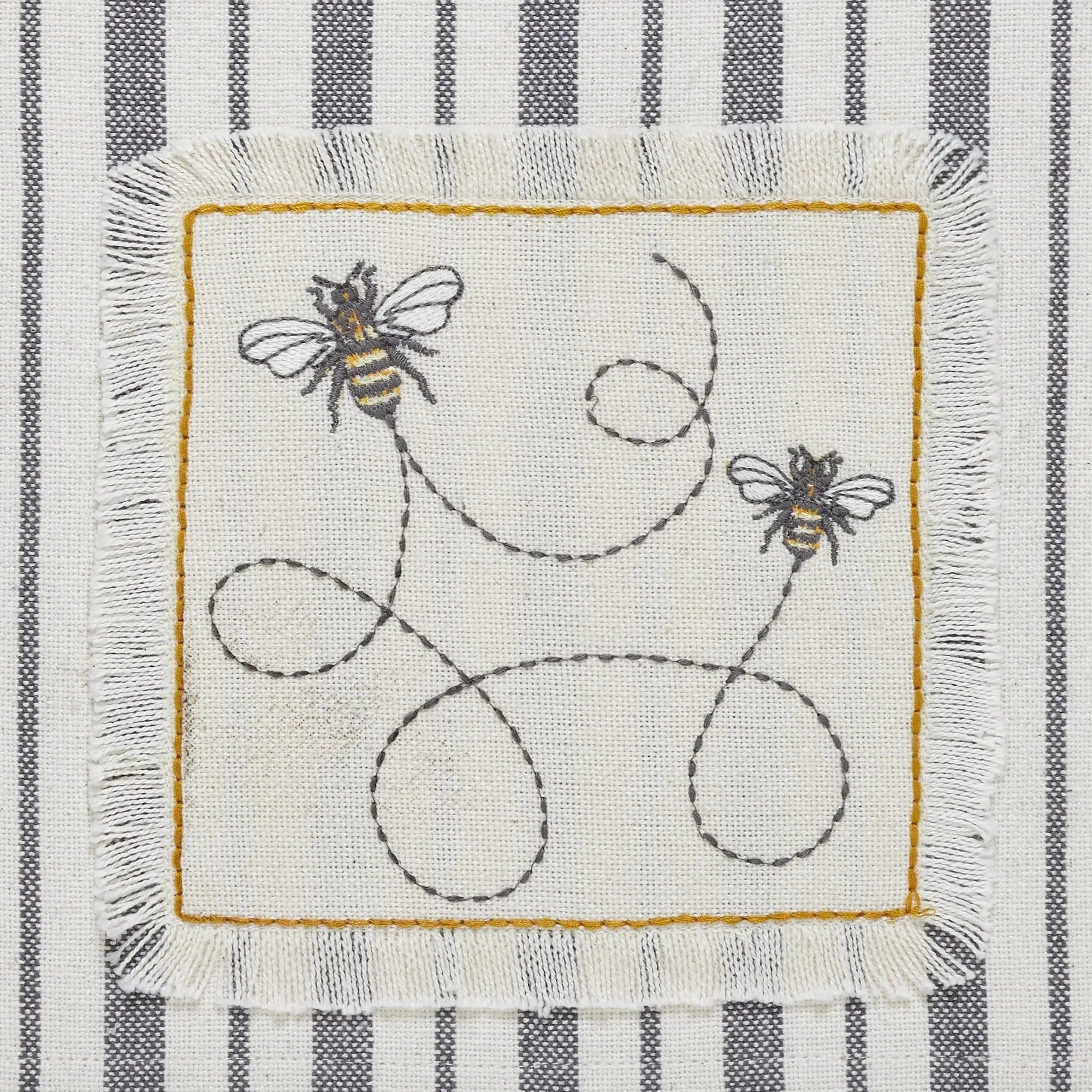 Farmhouse-style kitchen towel with embroidered bees and striped pattern, cozy cottage decor