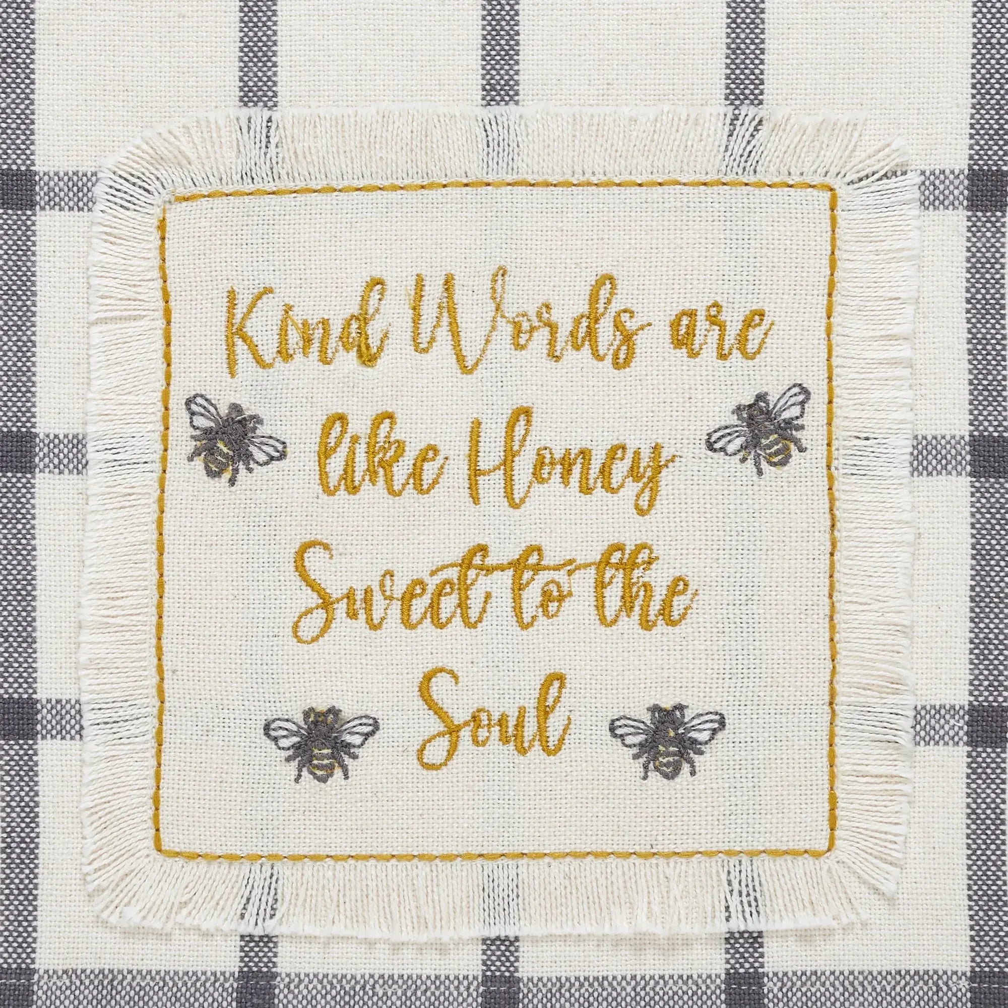 Farmhouse kitchen towel with embroidered bees and 'Kind Words are like Honey' quote on checkered background