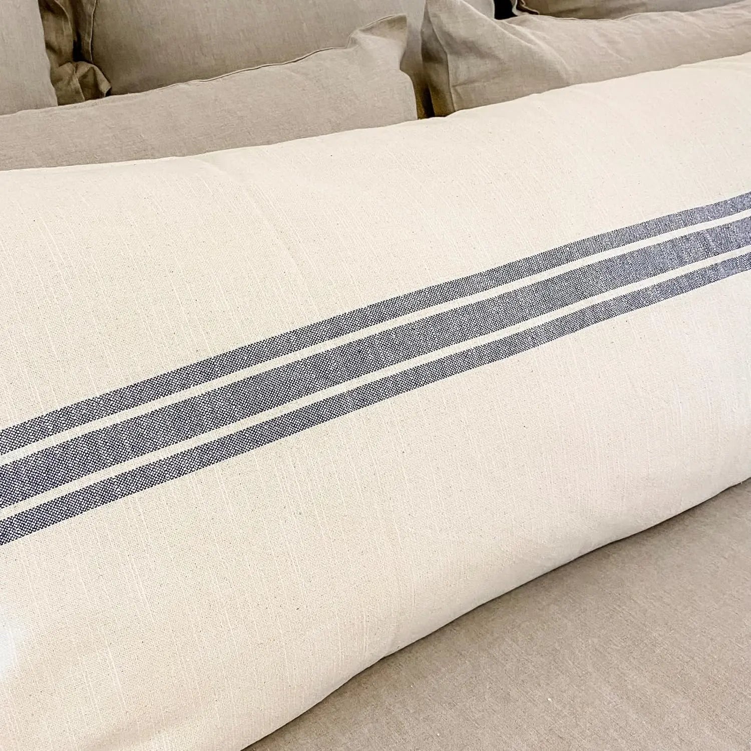 Beige pillow with blue stripes on a beige sofa