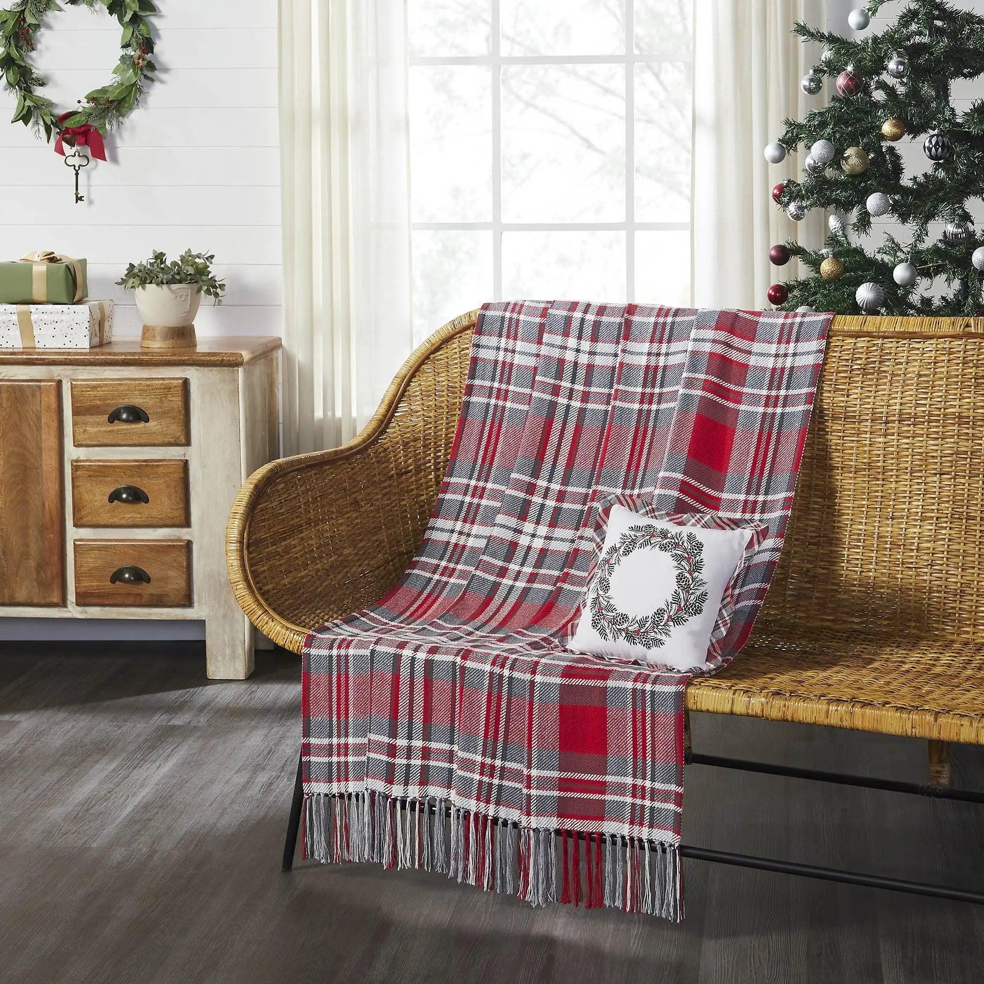 Red and gray plaid throw blanket with fringe on wicker bench, holiday decor, farmhouse style living room