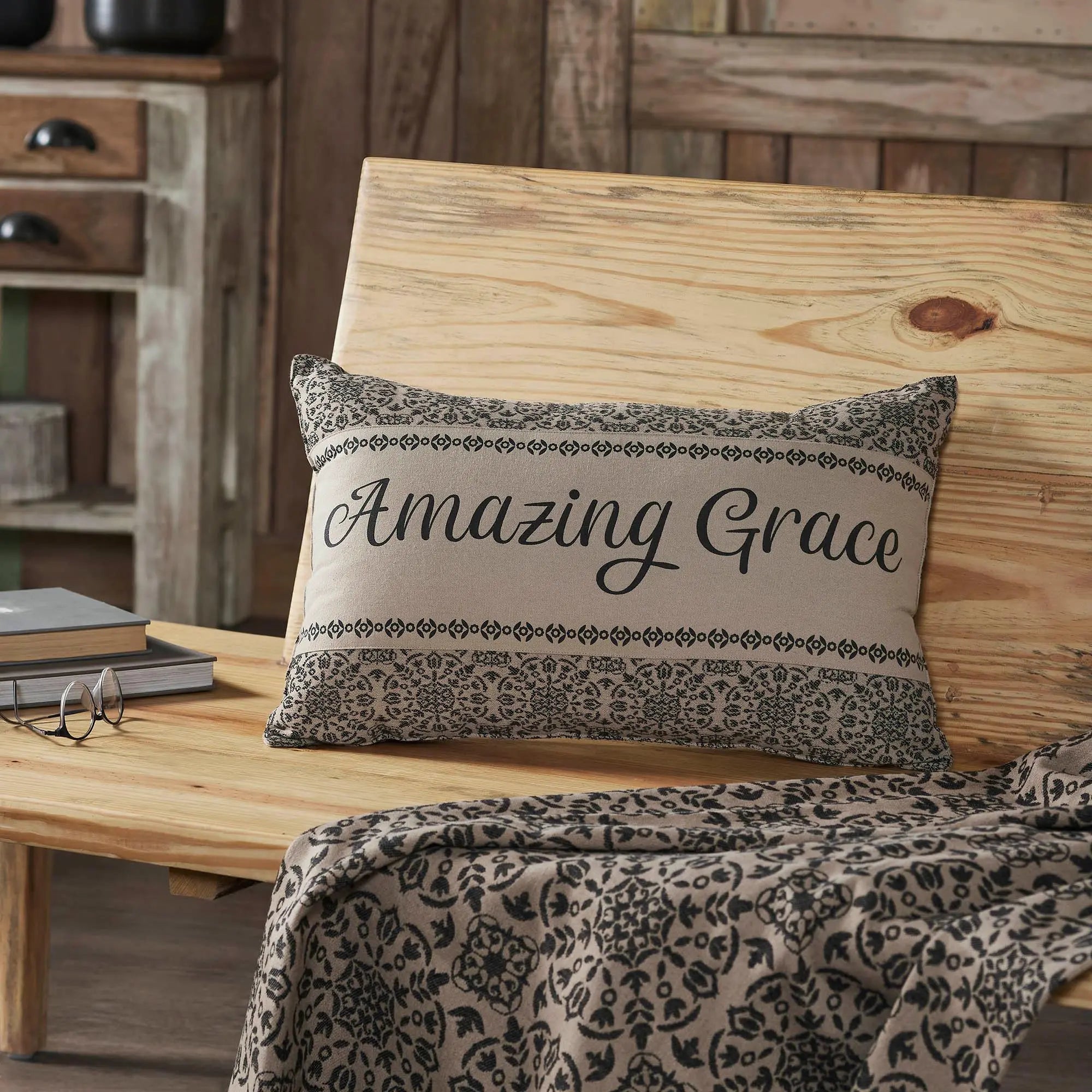 Amazing Grace throw pillow with floral pattern, cozy farmhouse decor on wooden chair