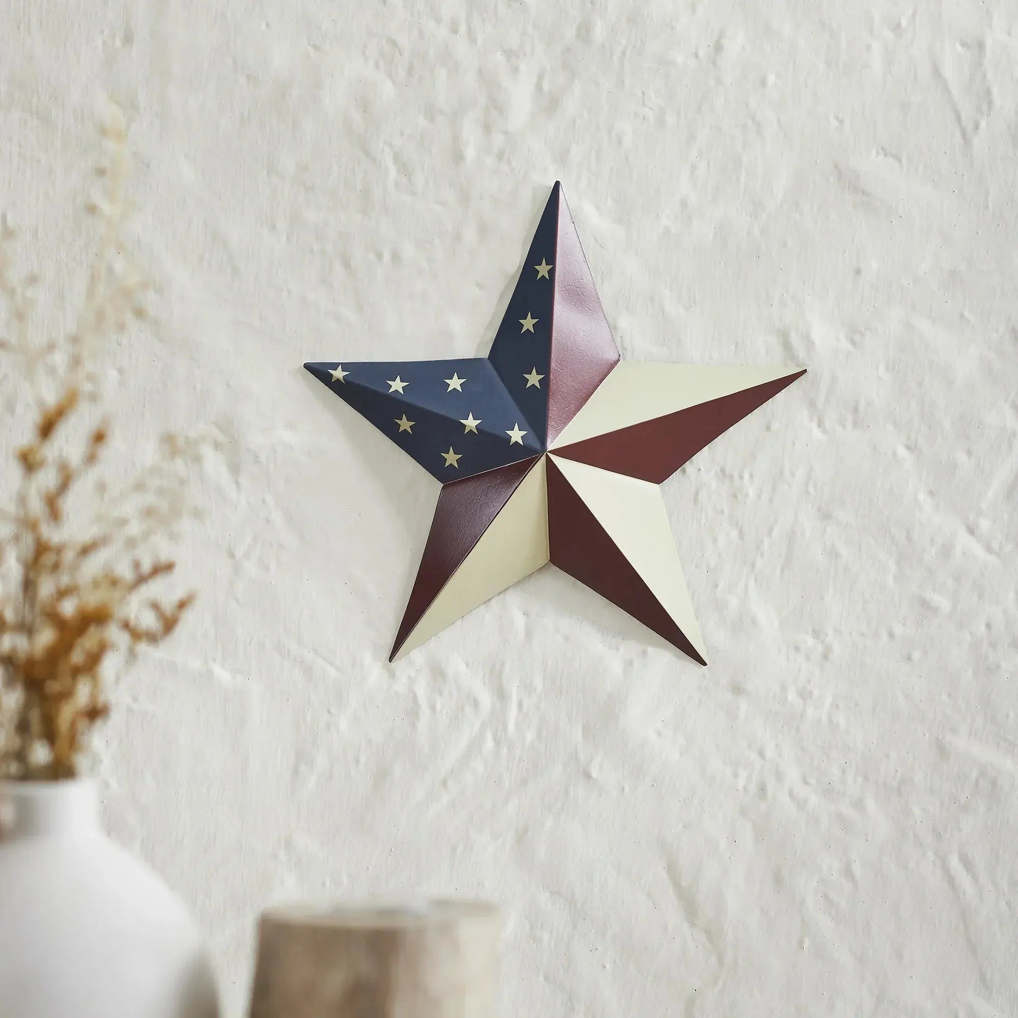 Decorative star wall art on a textured white wall