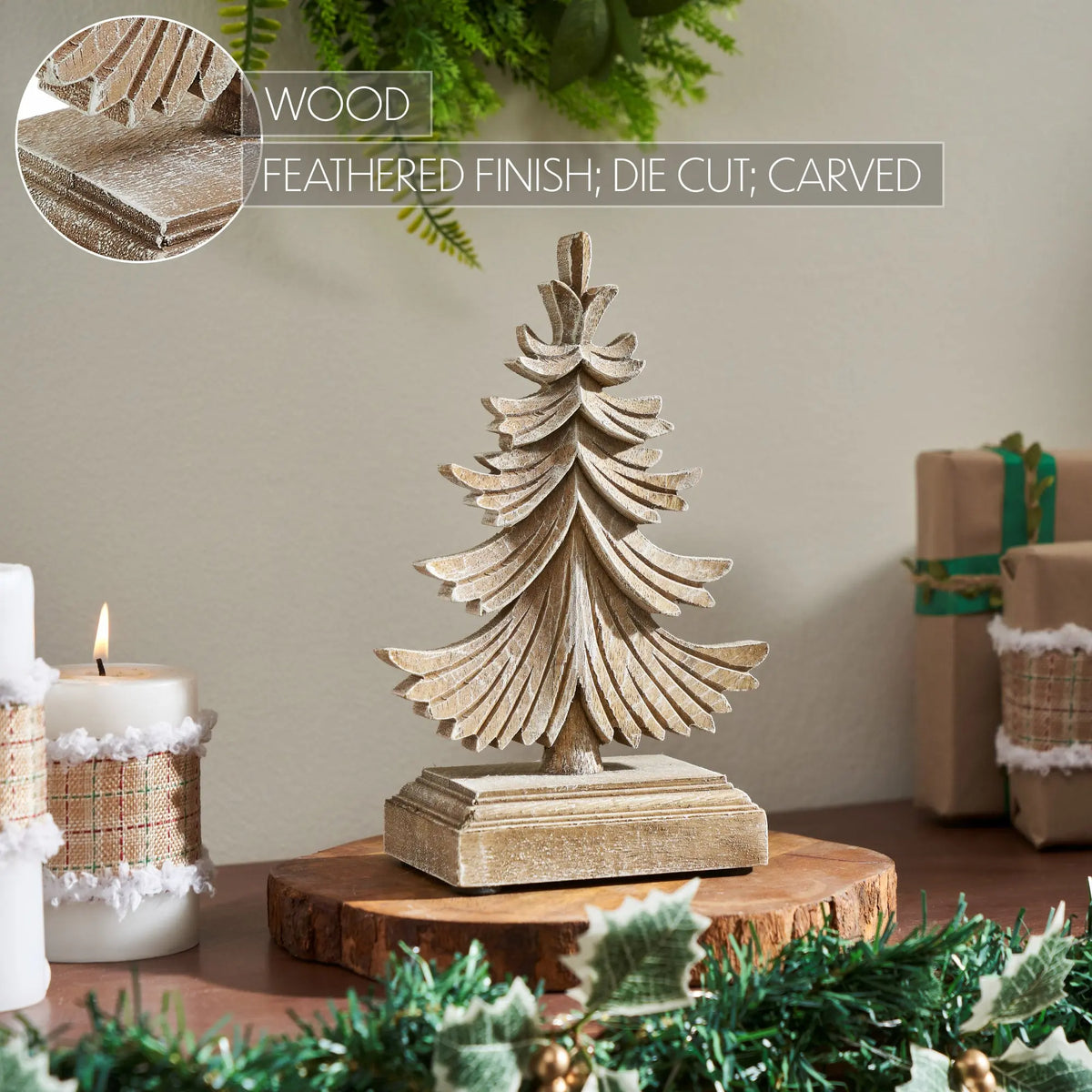 Wooden Christmas tree decoration on a table with candles and gift boxes in the background.