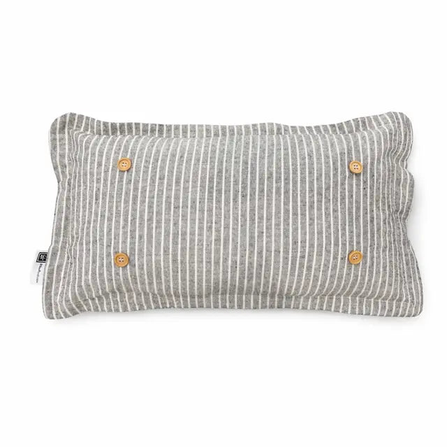 Gray striped pillow with button details on a white background