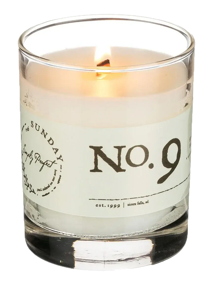 Lit No. 9 candle in clear glass jar, farmhouse-style home decor with cozy ambiance