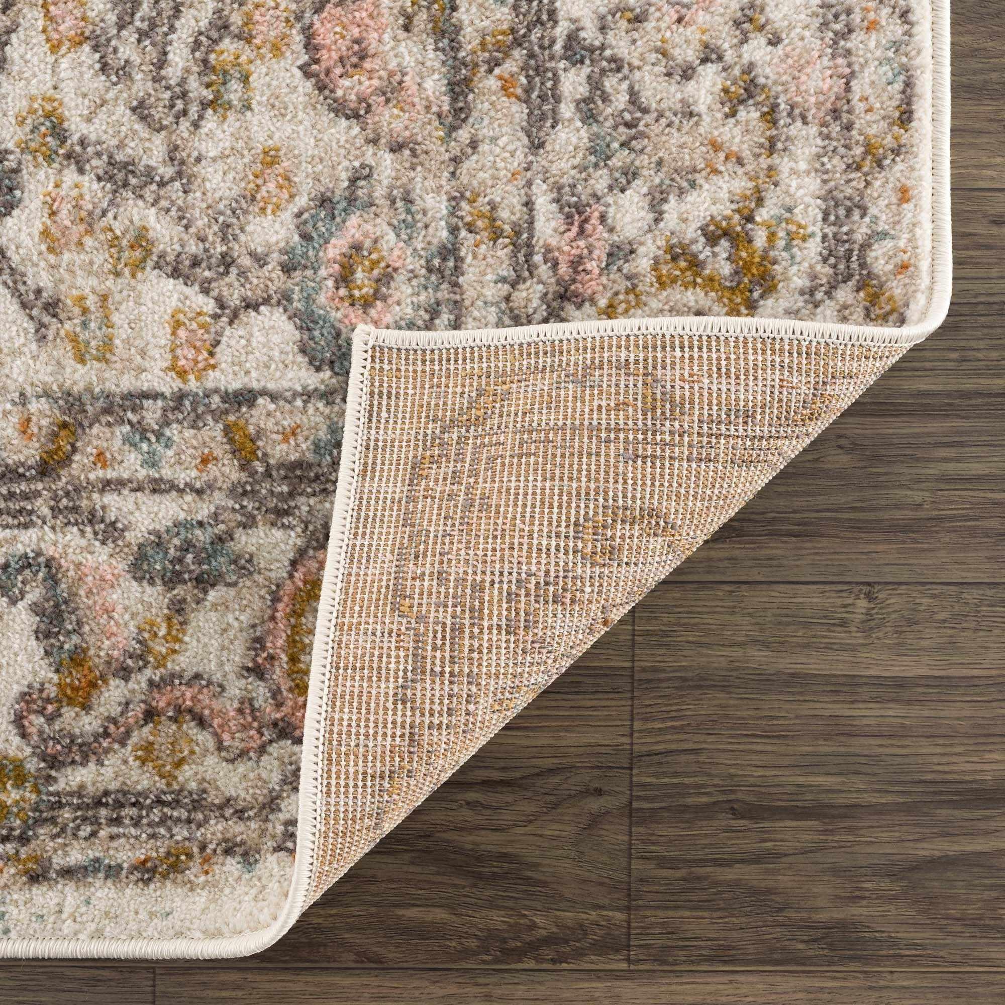 Cozy floral area rug with soft pastel tones and textured weave on wooden floor
