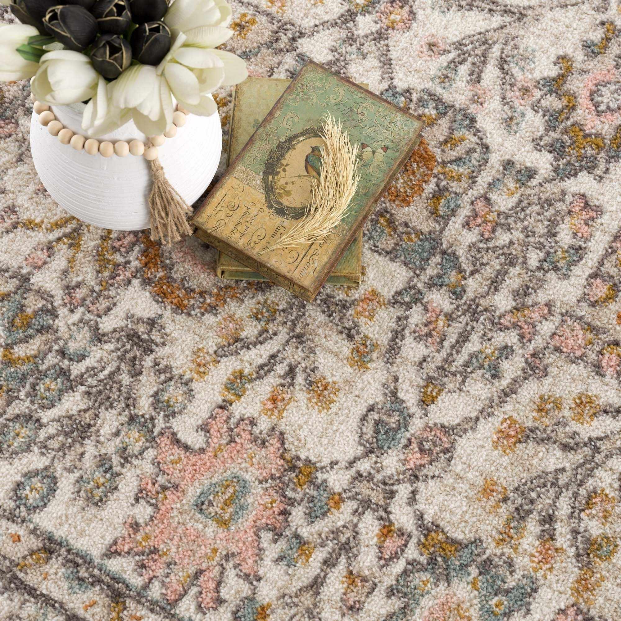 Cozy farmhouse area rug with vintage books, white tulips, and dried wheat in a cottage-style living space