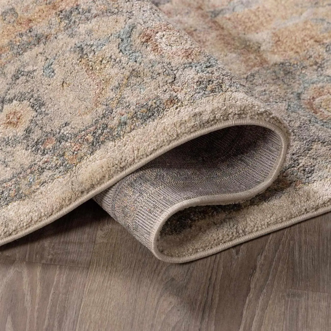 Cozy farmhouse area rug with vintage floral pattern, soft texture, and neutral tones for living room decor