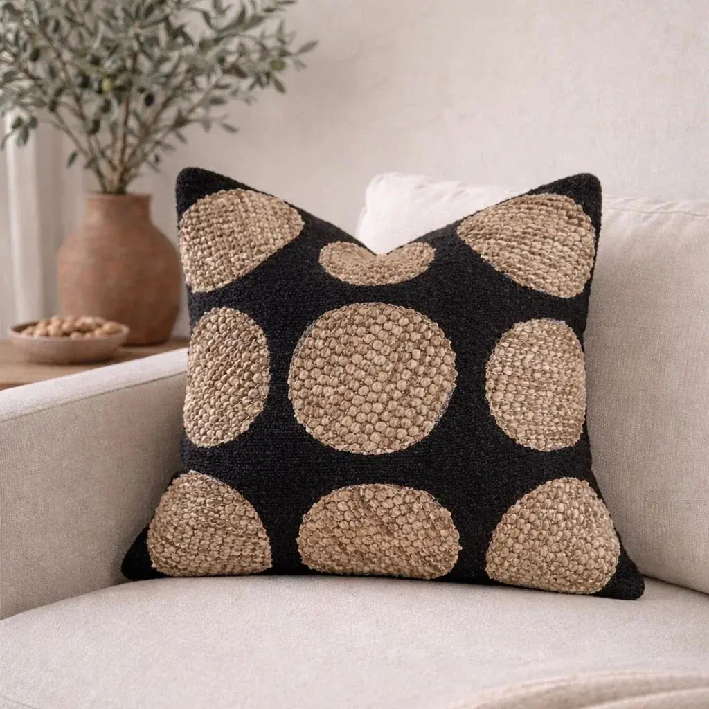 Black and beige textured polka dot throw pillow on cozy sofa, farmhouse decor accent