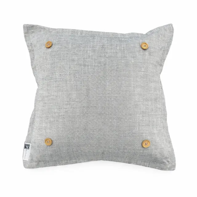 A square light gray linen throw pillow with four natural wood buttons on the corners, shown against a plain white background.